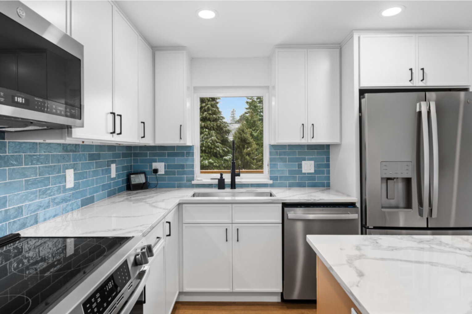 Modern kitchen renovation by F&M Construction & Remodeling in Seattle, WA, showcasing custom cabinetry, quartz countertops, subway tile backsplash, and functional kitchen design for luxury home remodeling projects.