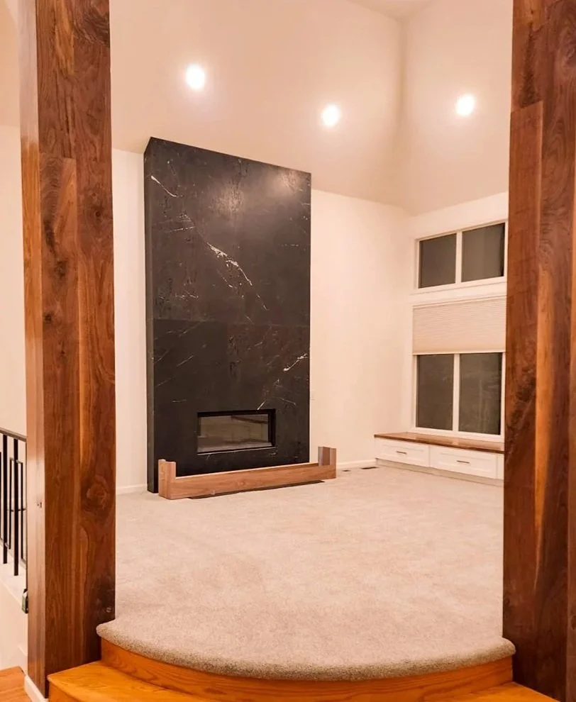 Modern black stone fireplace installation completed by F&M Construction & Remodeling on Mercer Island, WA, featuring a custom linear fireplace, premium stone surround, and luxury home remodeling for Bellevue, Seattle, and the Eastside.
