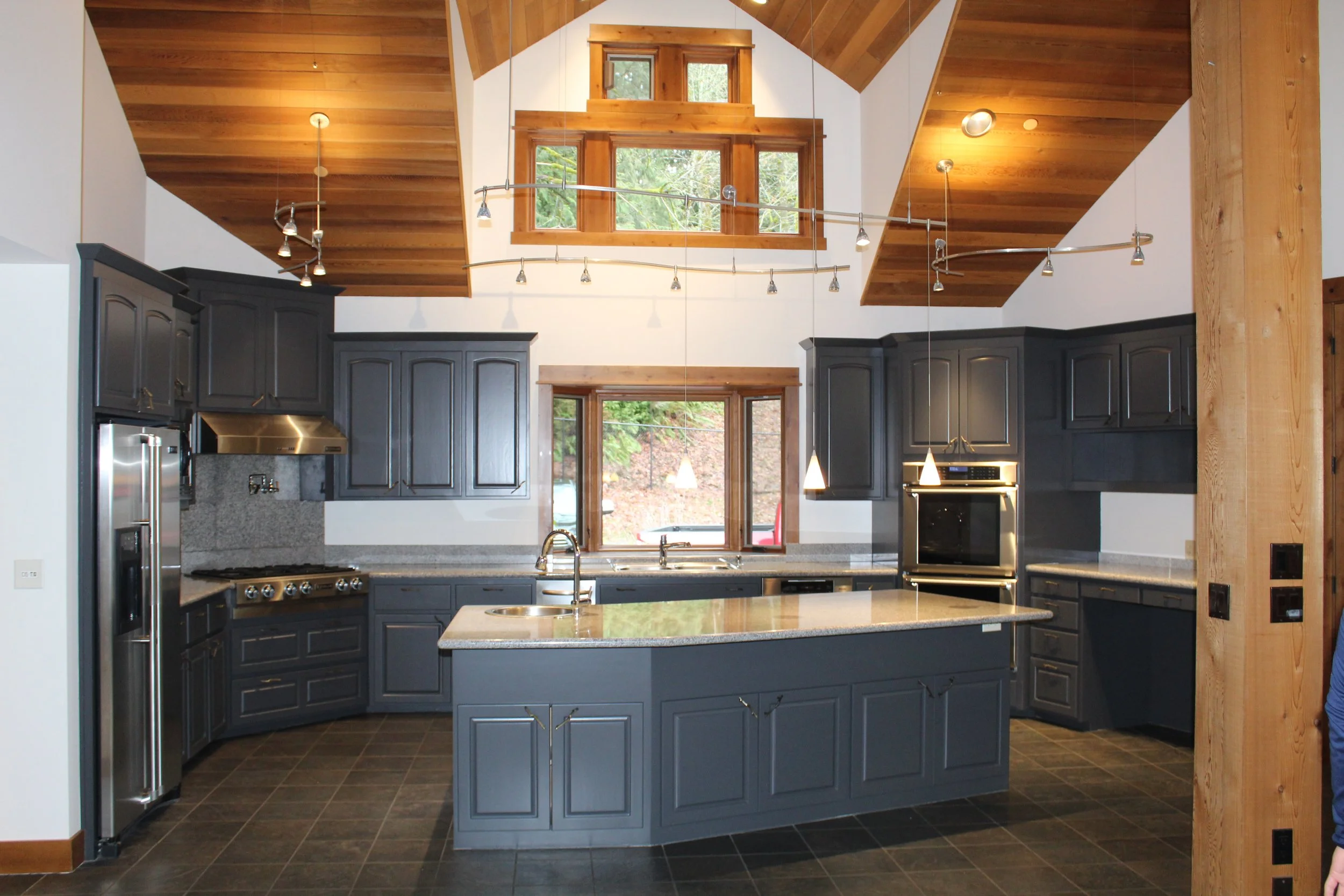Luxury kitchen remodeling project completed by F&M Construction & Remodeling in Bellevue, WA, featuring custom cabinetry, oversized island, vaulted ceilings, premium appliances, and high-end residential remodeling expertise.