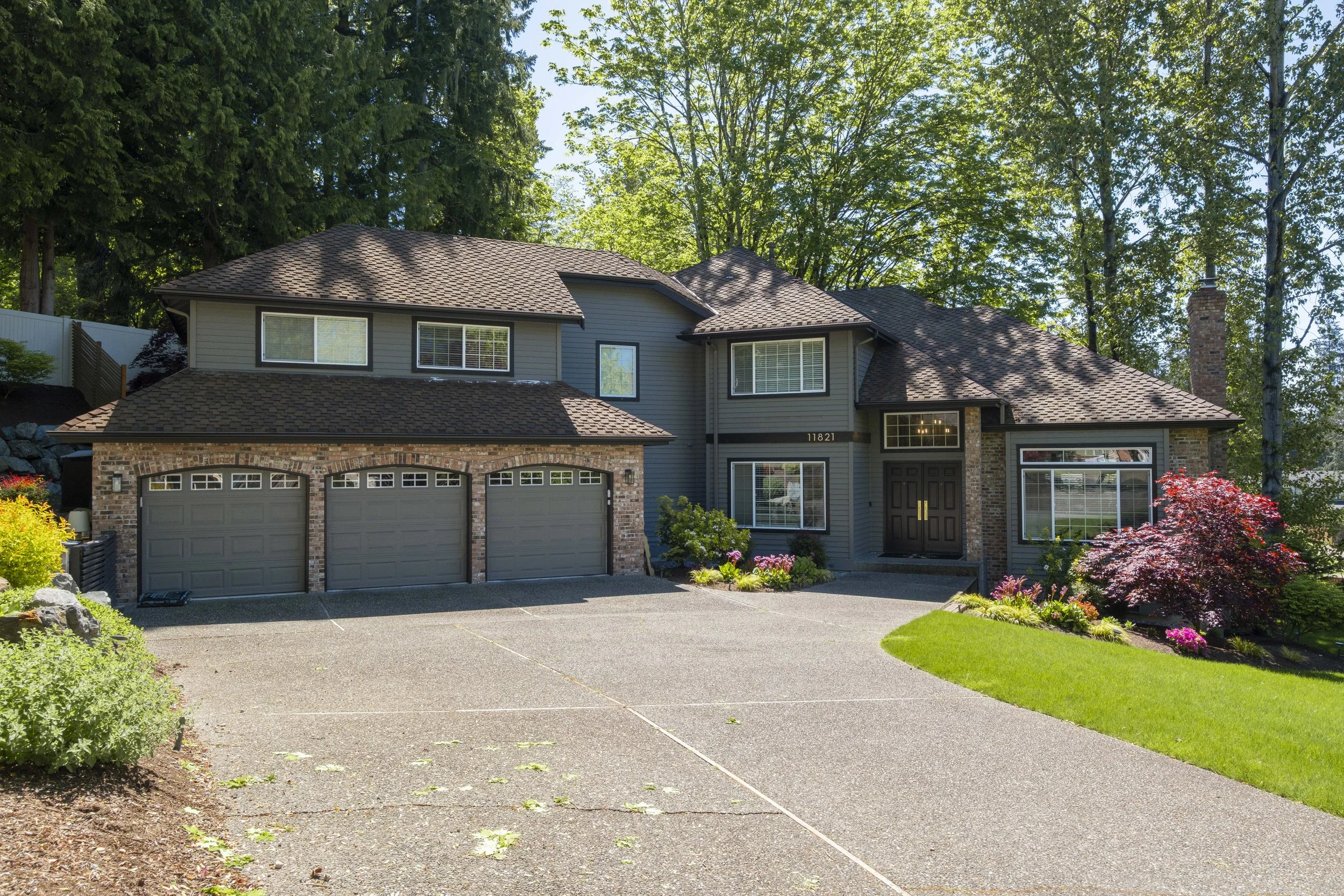 Beautiful home exterior featuring professional landscaping, manicured lawn, mature trees, and enhanced curb appeal representing the landscaping services provided by F&M Construction & Remodeling.