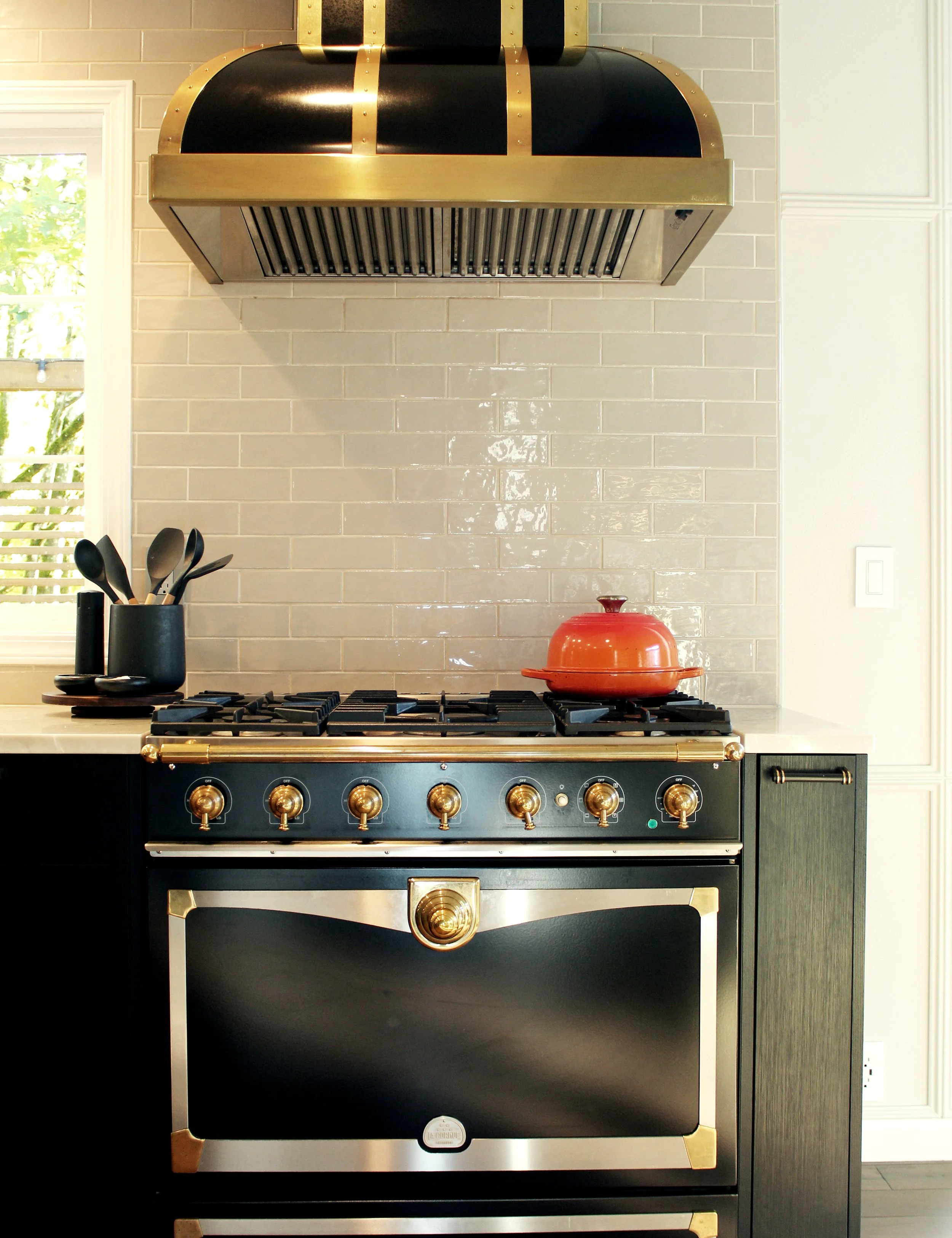 Professional range installation completed by F&M Construction & Remodeling in Kirkland, WA, featuring a luxury gas range, custom cabinetry, and premium kitchen appliance installation for high-end residential remodeling.