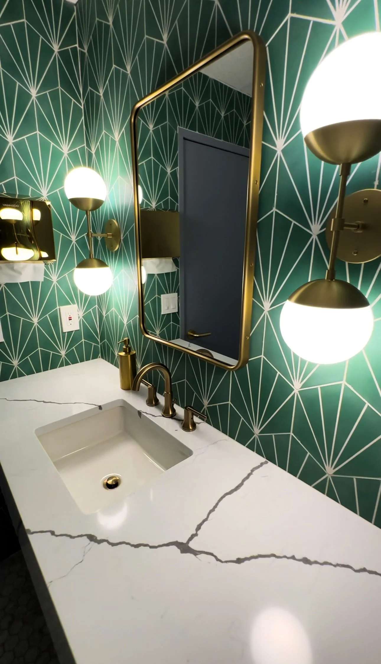 Bathroom remodeling project completed by F&M Construction & Remodeling in Bellevue, WA, featuring custom vanity, designer wallpaper, premium lighting, and luxury bathroom finishes for Eastside homeowners.