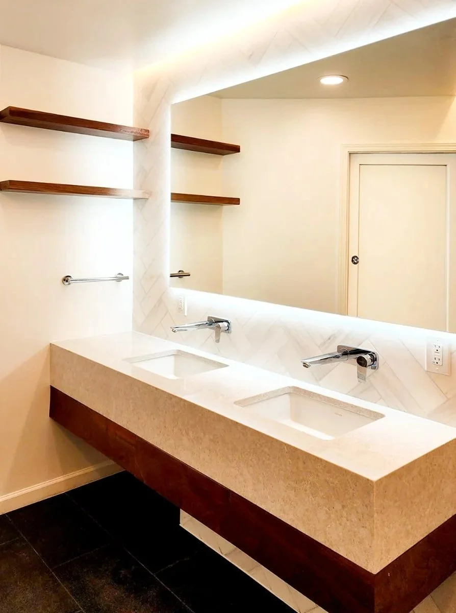 LED bathroom vanity lighting installation completed by F&M Construction & Remodeling in Seattle, WA, featuring modern bathroom light fixtures, floating shelves, and luxury bathroom remodeling for Bellevue and the Eastside.