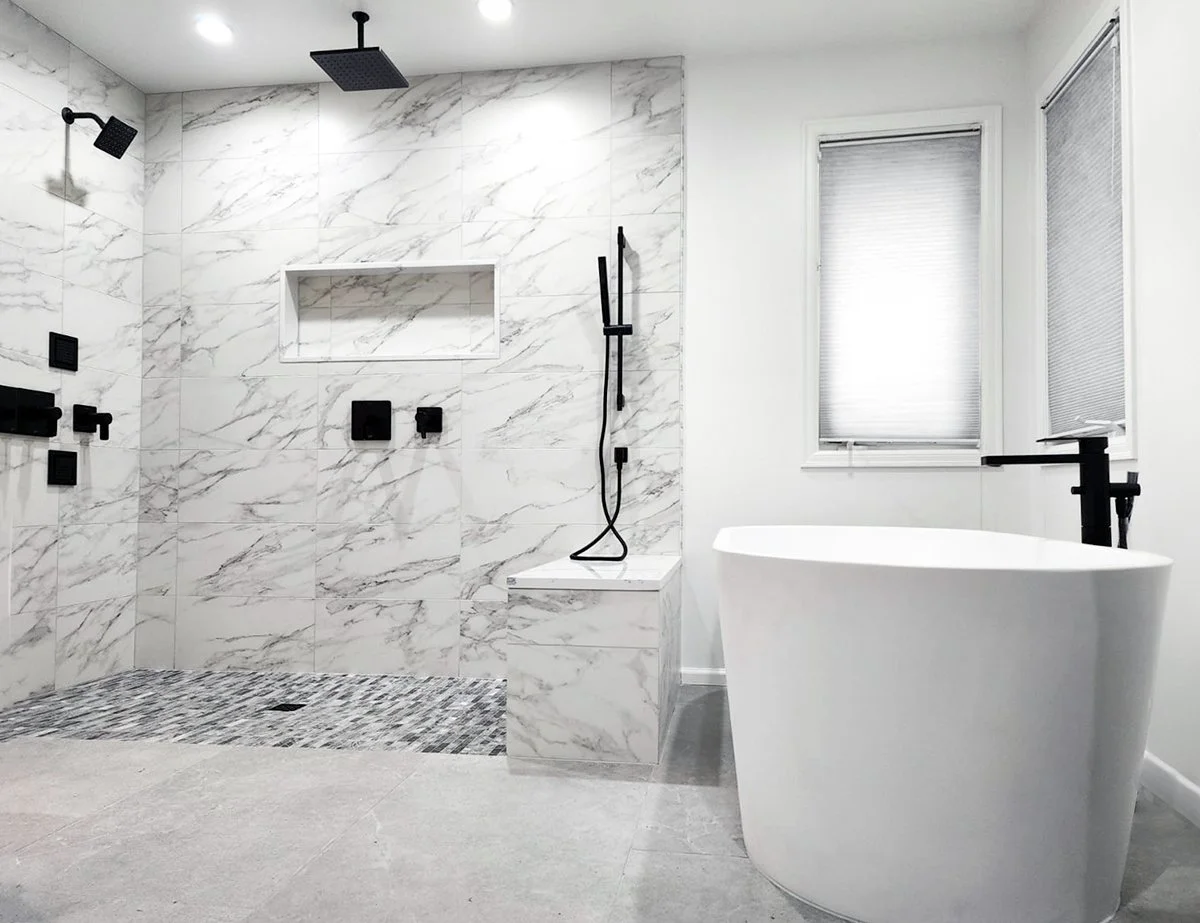Modern bathroom renovation by F&M Construction & Remodeling in Seattle, WA, showcasing a walk-in shower, freestanding soaking tub, marble tile, and premium bathroom remodeling craftsmanship.