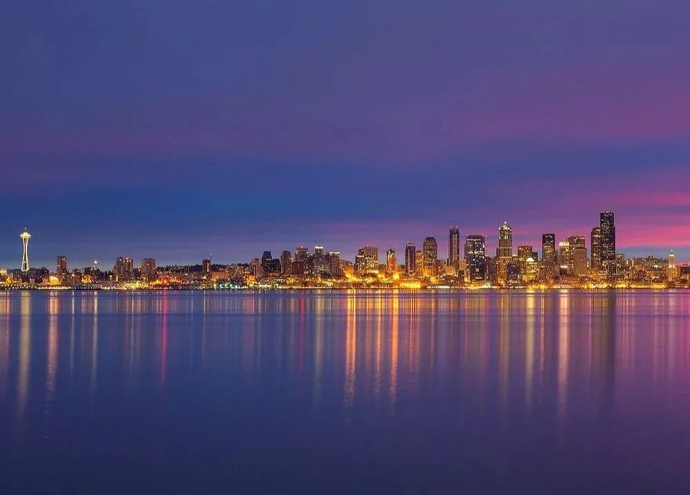 Seattle skyline viewed from Alki Beach, showcasing downtown Seattle across Elliott Bay.