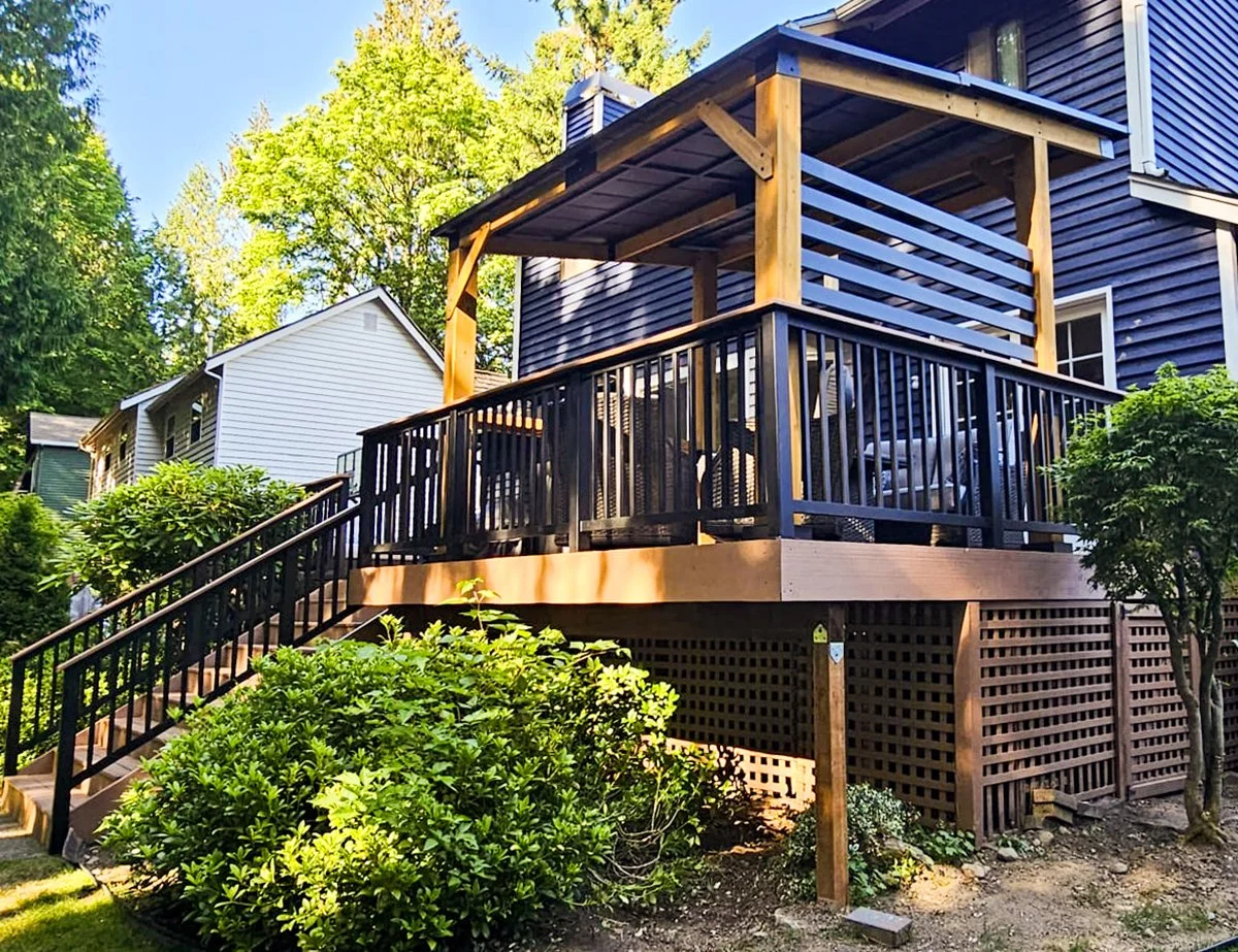 Custom covered patio and outdoor living space completed by F&M Construction & Remodeling in Bellevue, WA, featuring an elevated composite deck, covered gathering area, and premium outdoor remodeling craftsmanship.