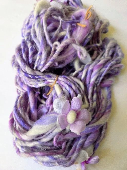 Hand spun purple and white yarn with silk flowers