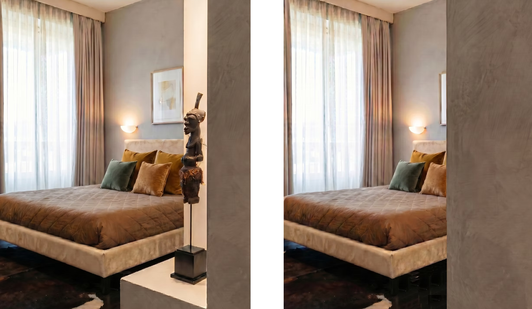 A cozy bedroom featuring a large bed with a beige velvet headboard, brown quilt, and multiple pillows in green, brown, and beige. The room has large windows with sheer white curtains and beige drapes. There's a wall-mounted light fixture above the bed, a framed artwork on the wall, and an African-style sculpture on a stand beside the bed.