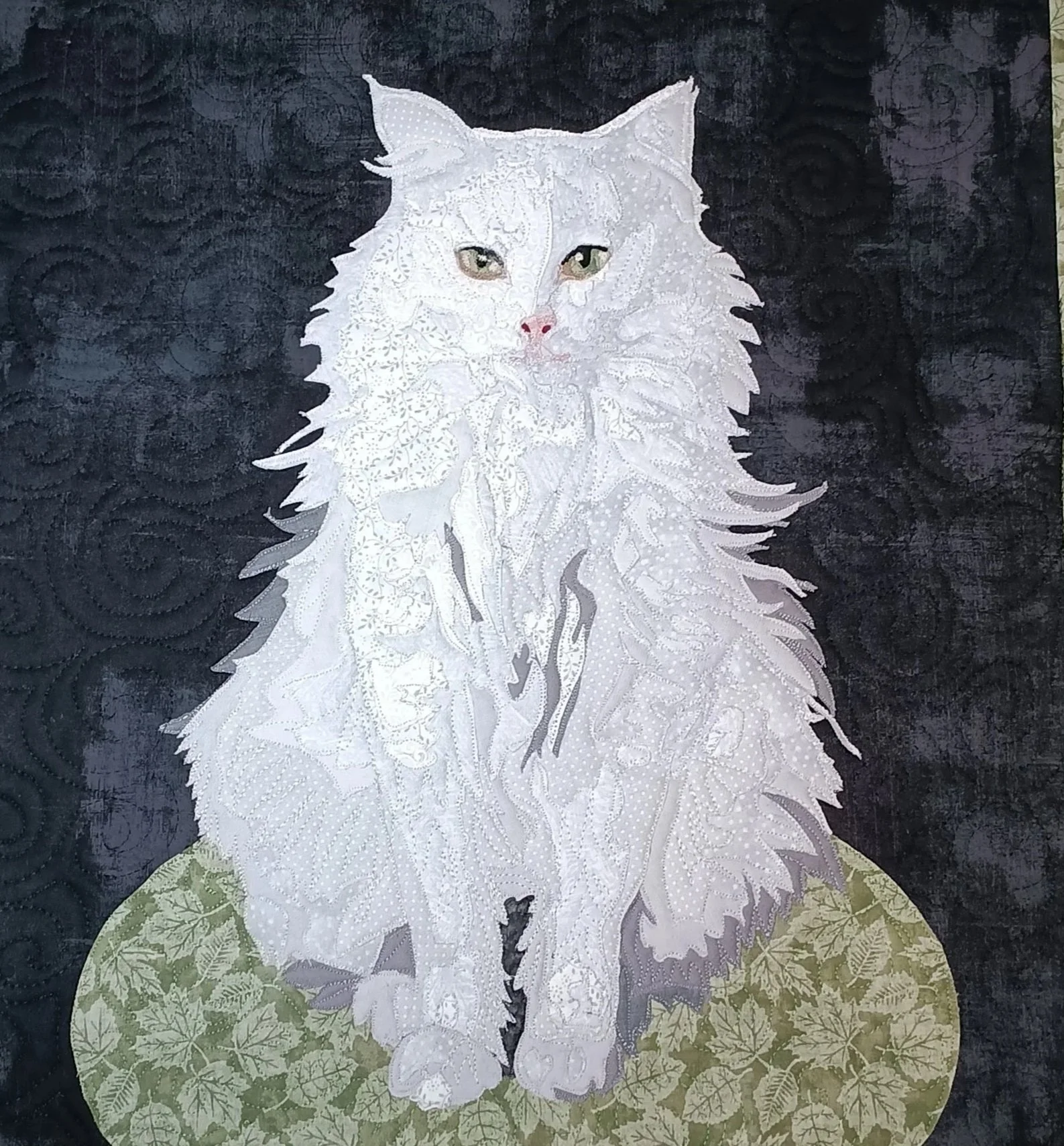 Artistic portrait of a white feline with piercing eyes, set against a dark background with a decorative circular pattern at the bottom.