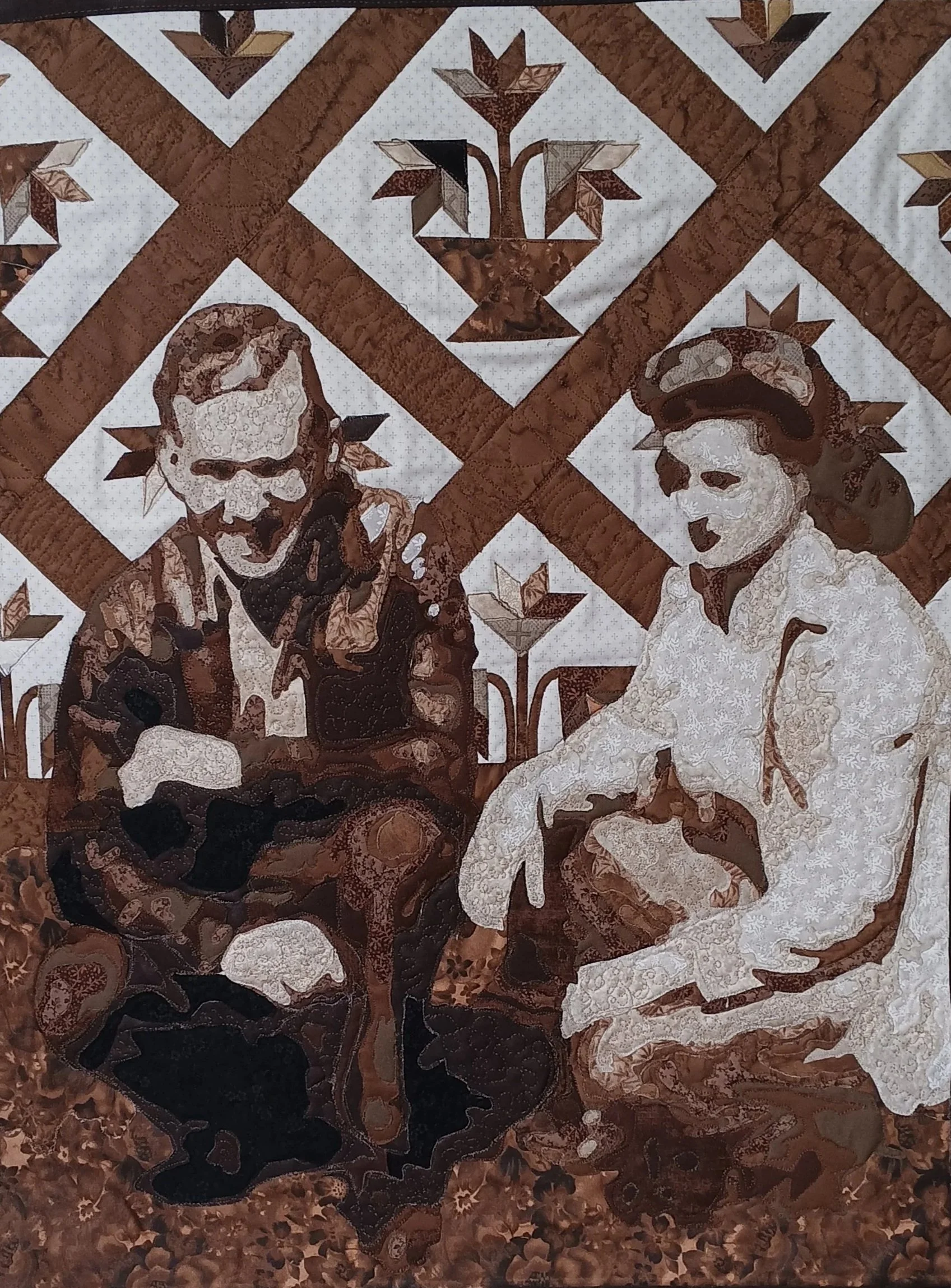 A quilt with a brown and white pattern featuring a man with a beard and a woman in vintage attire, holding hands, surrounded by stars and floral motifs.