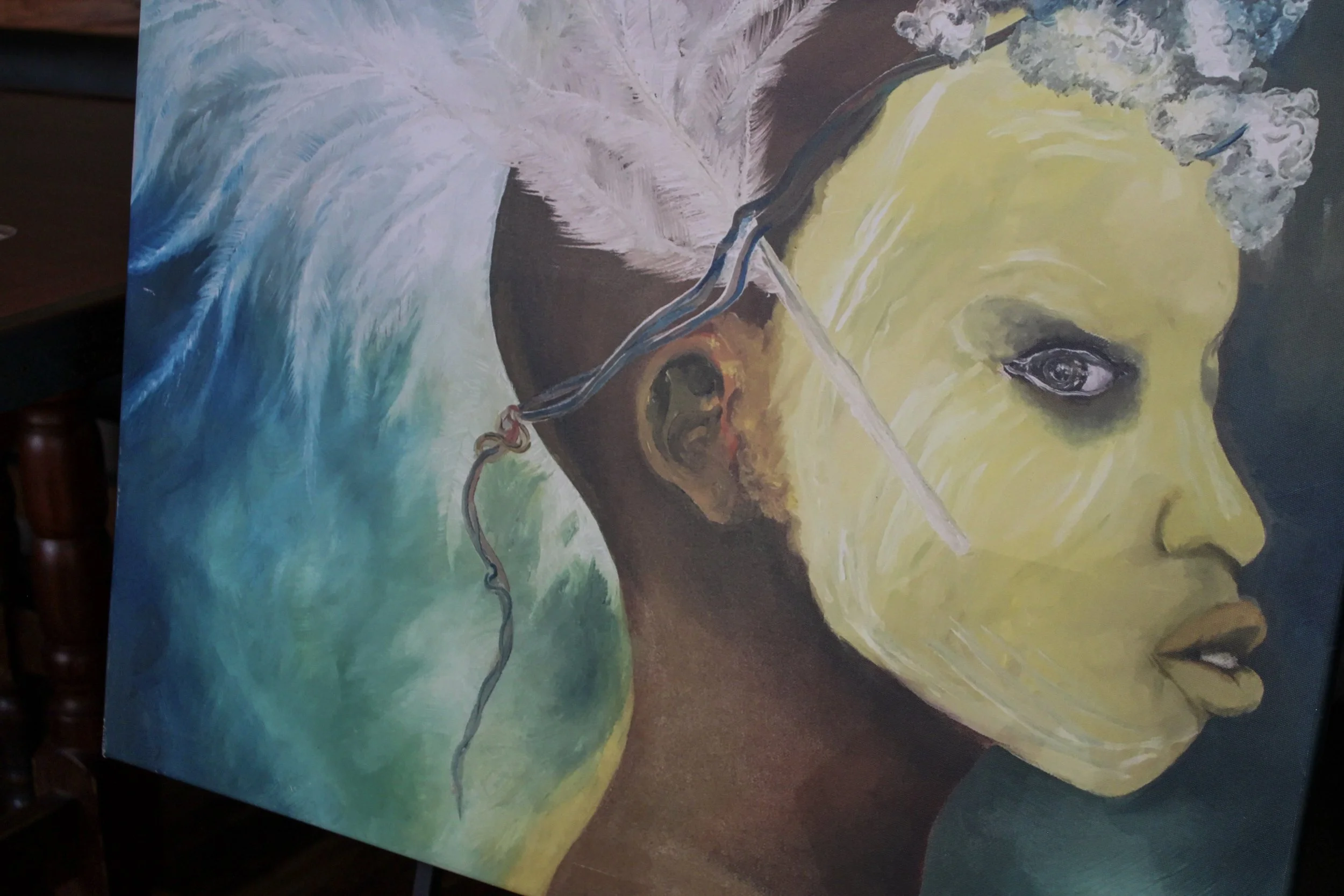 Painting of a woman with dark skin, large eye, and yellowish face, with abstract background in blue and green hues.