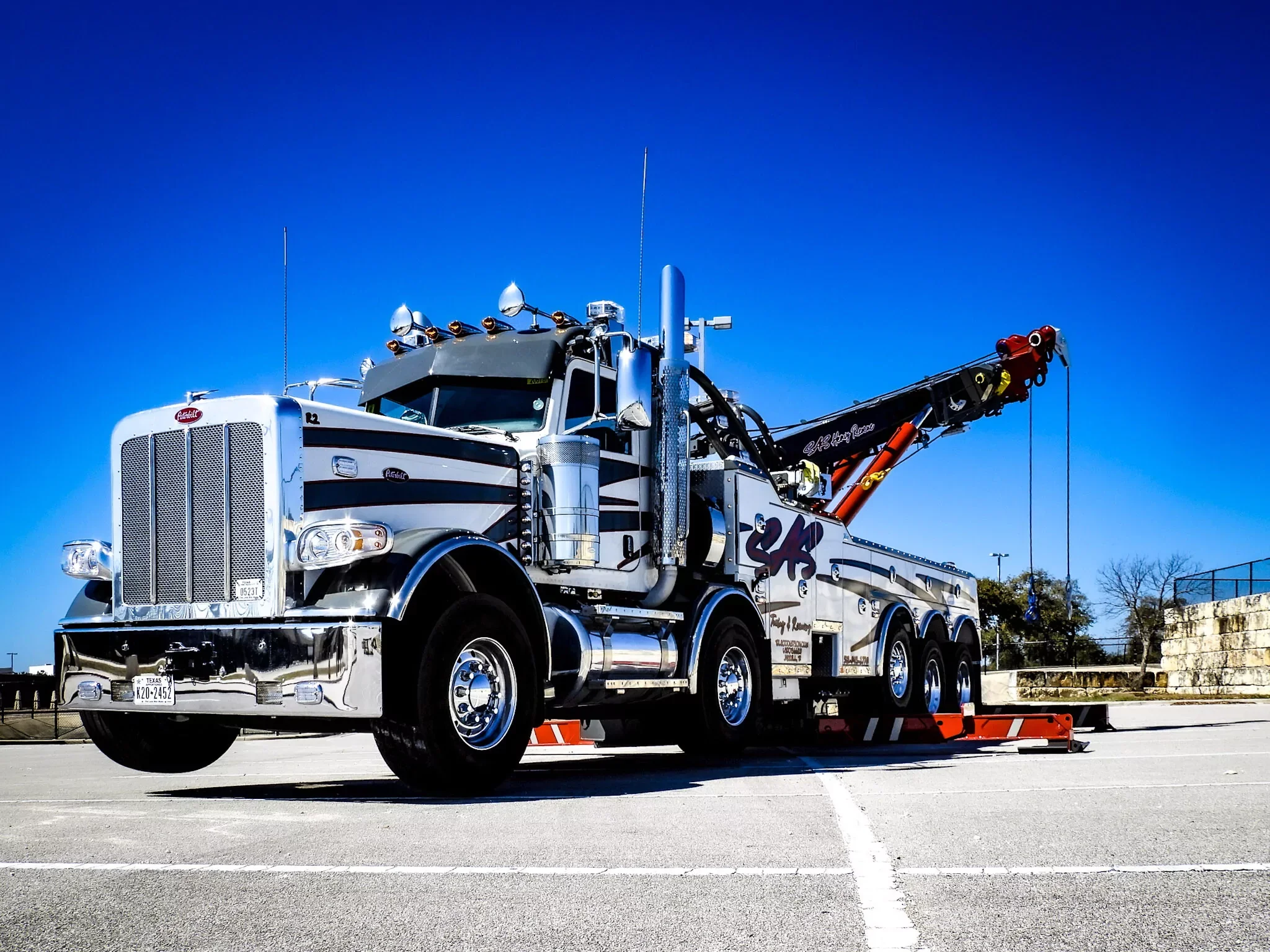 Black and silver SAS Road Solutions heavy-duty rotator tow truck