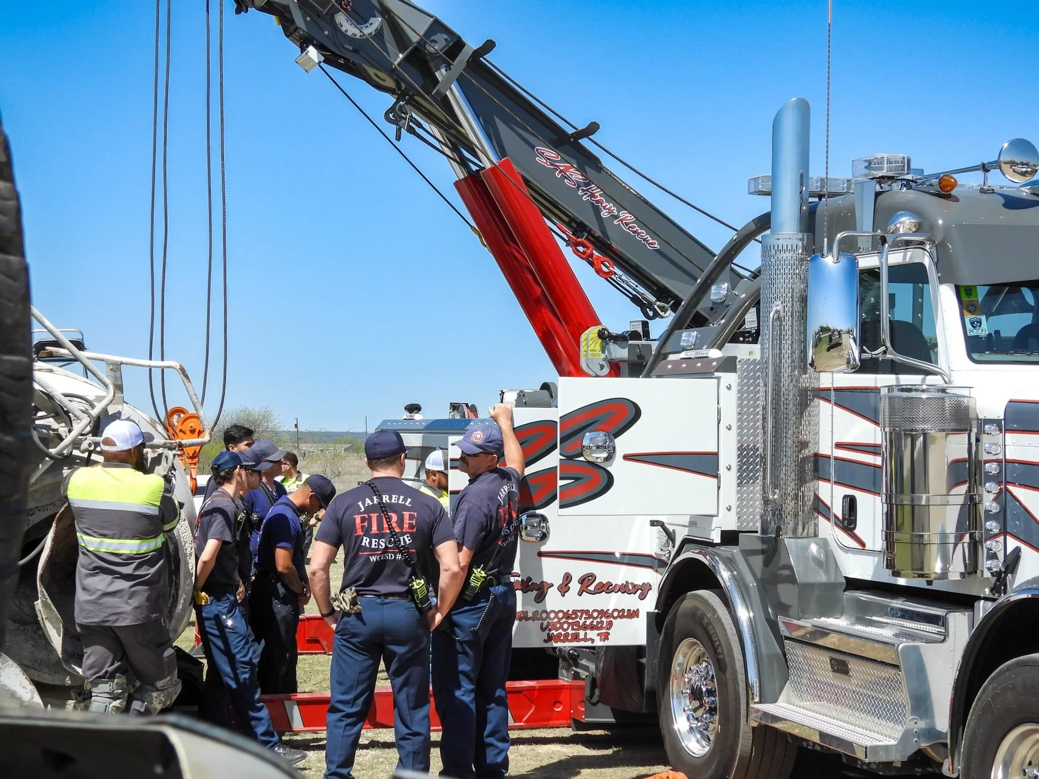 SAS Road Solutions heavy-duty recovery crew operating a rotator tow truck at an emergency scene