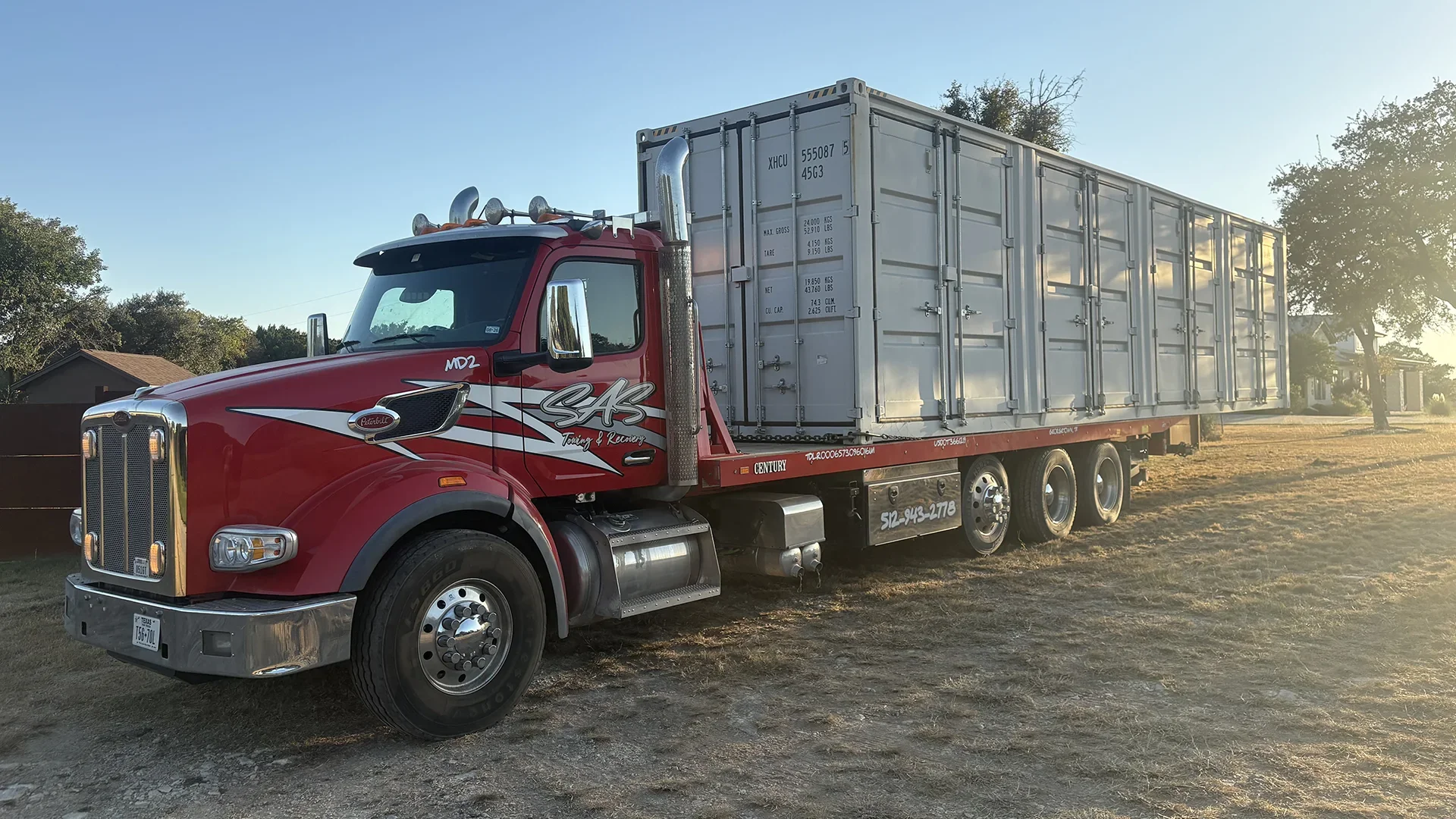 SAS Road Solutions tractor transporting a large shipping container