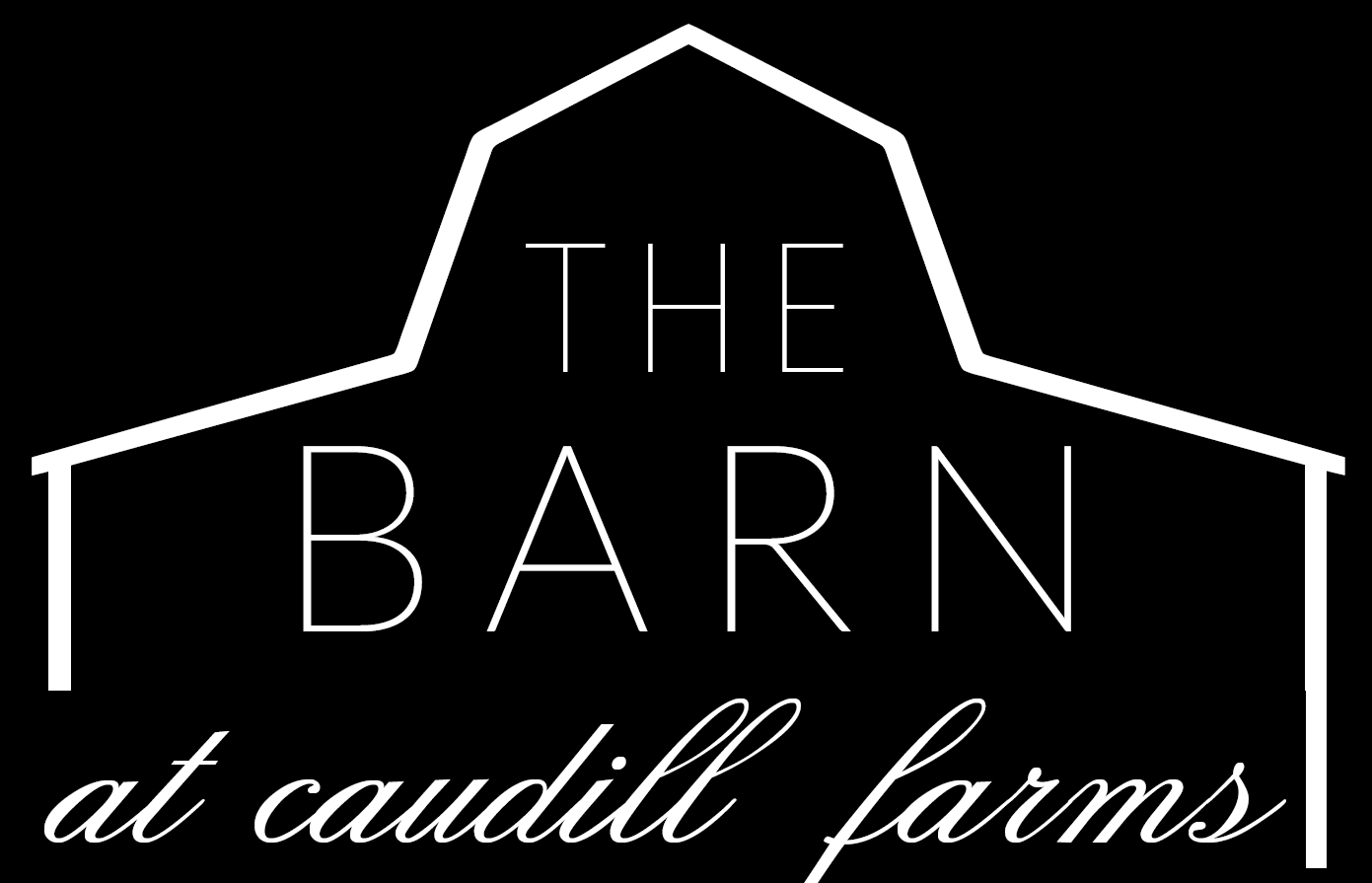 Logo of a barn with the text 'The Barn at Caudill Farms' in a black and white design, with a stylized outline of a barn roof.