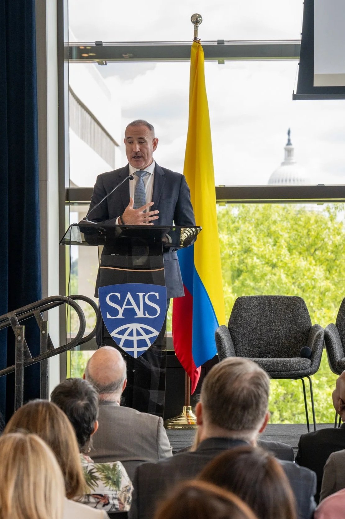 Dr. Albert “Jim” Marckwardt speaking at a Johns Hopkins SAIS podium during an event focused on Colombia.