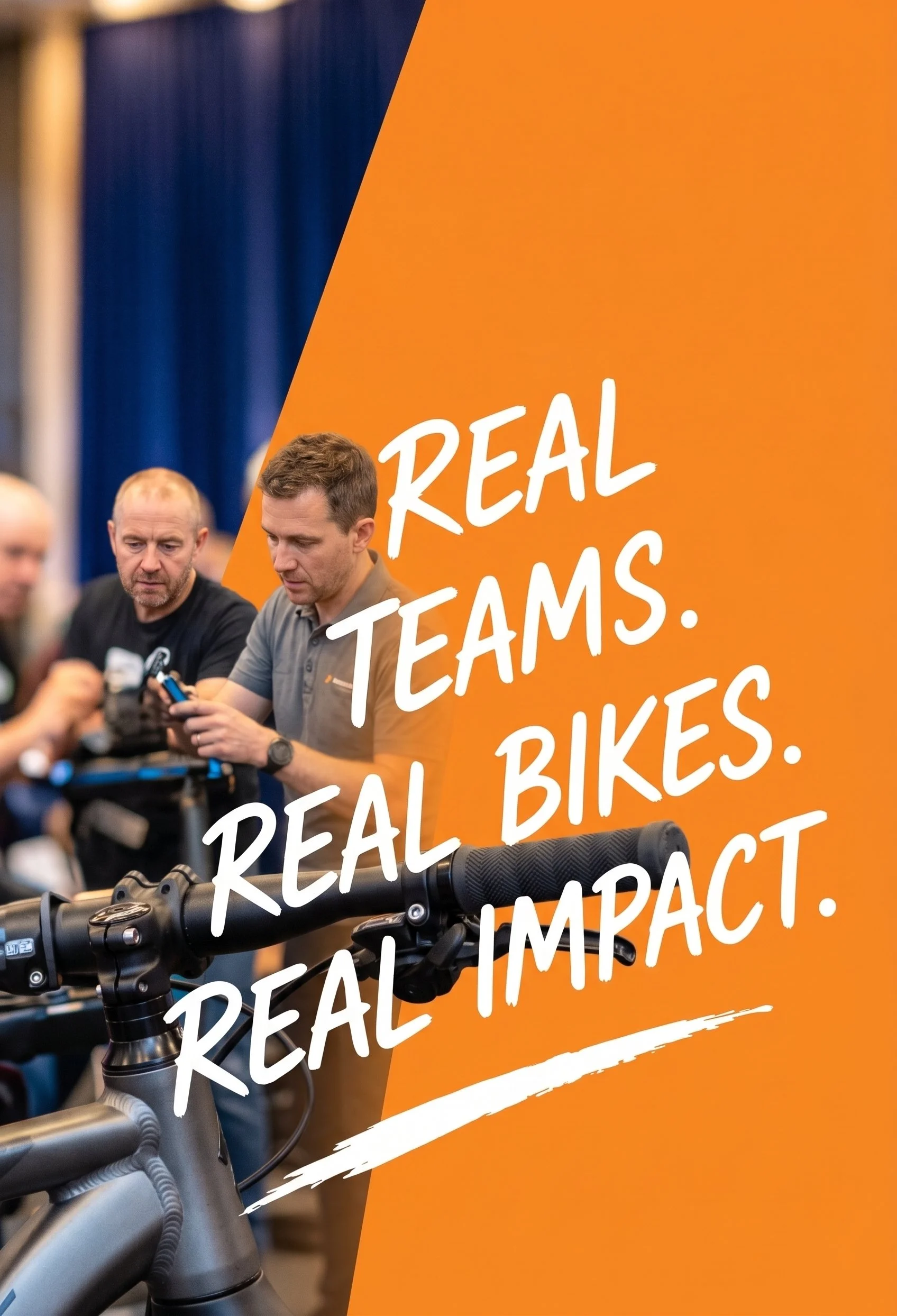 People at an event with a large orange banner with white text that reads, 'REAL TEAMS. REAL BIKES. REAL IMPACT.' An electric bike is in the foreground and two men are looking at their phones in the background.