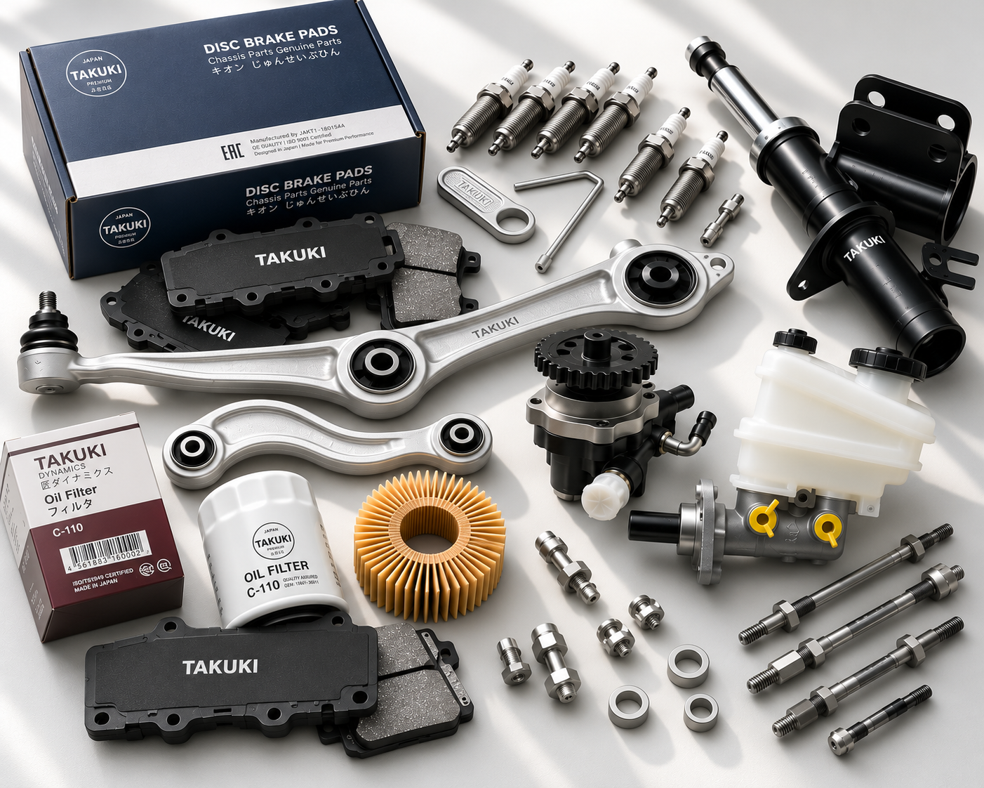 Automotive parts including brake pads, spark plugs, a shock absorber, oil filter, gears, small nuts and bolts, and other engine components on a white surface.