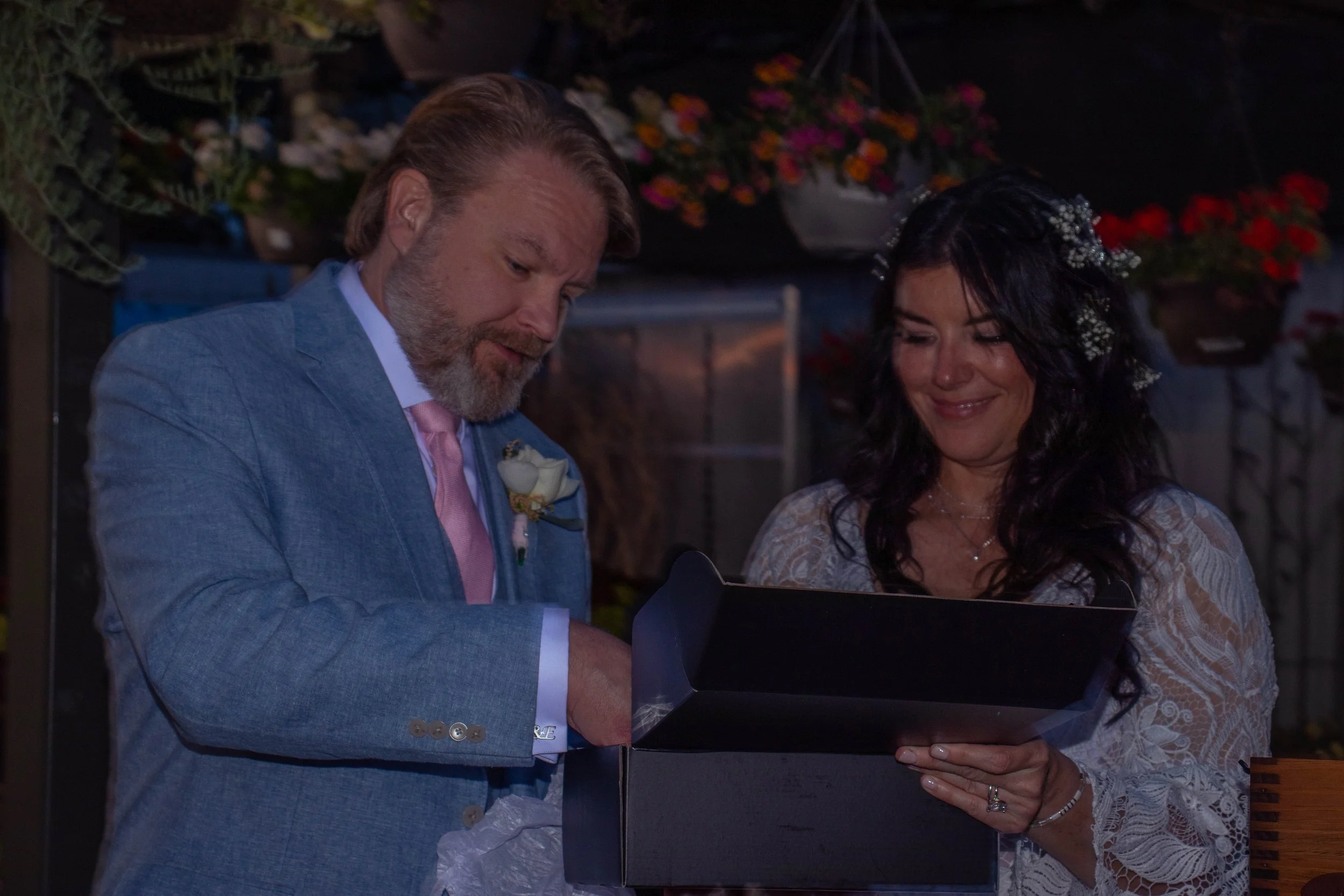 A man and a woman exchanging rings during a wedding ceremony.