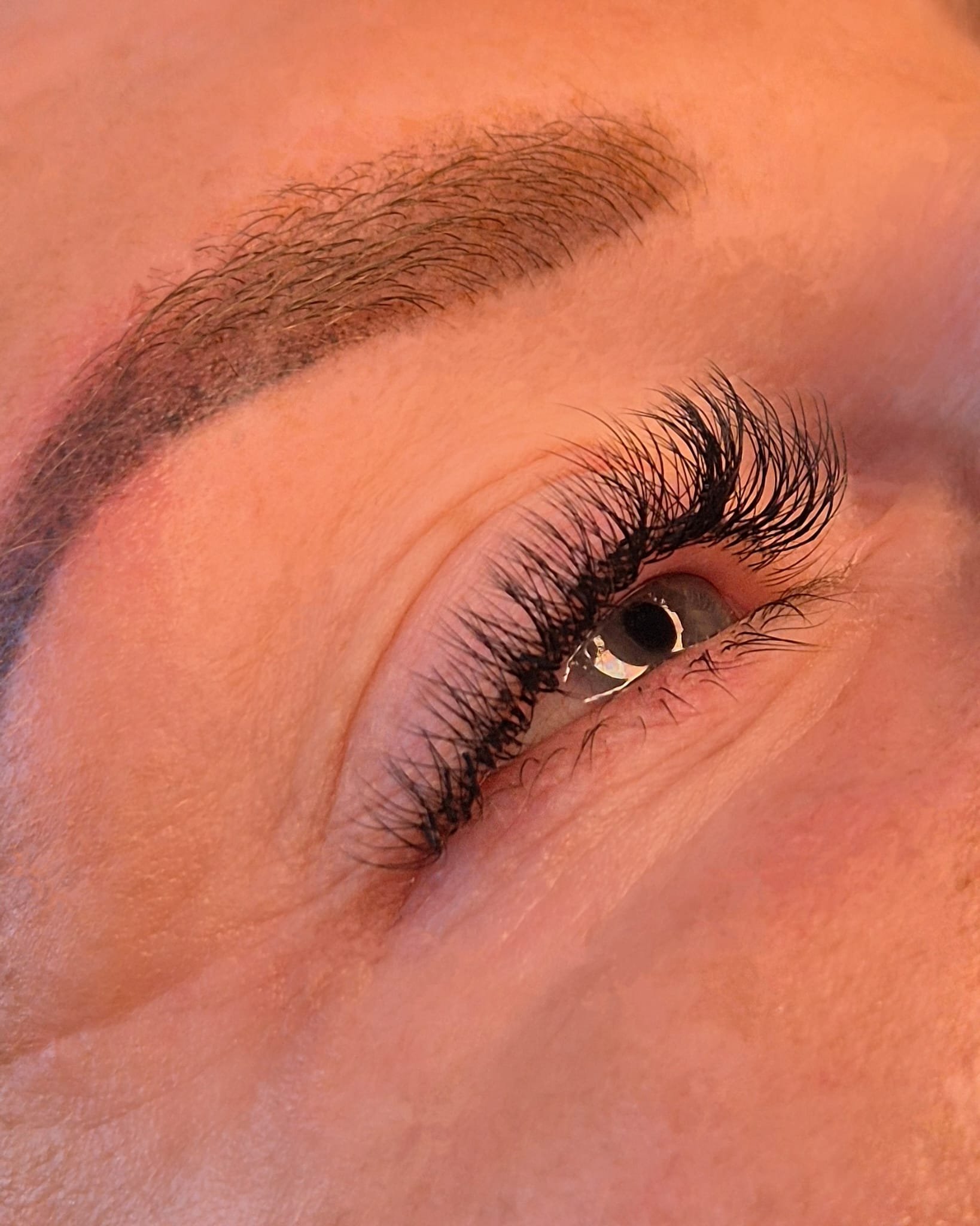Close-up of a person's eye facing right with hybrid lash extensions by k.beautystudio Aberdeen.