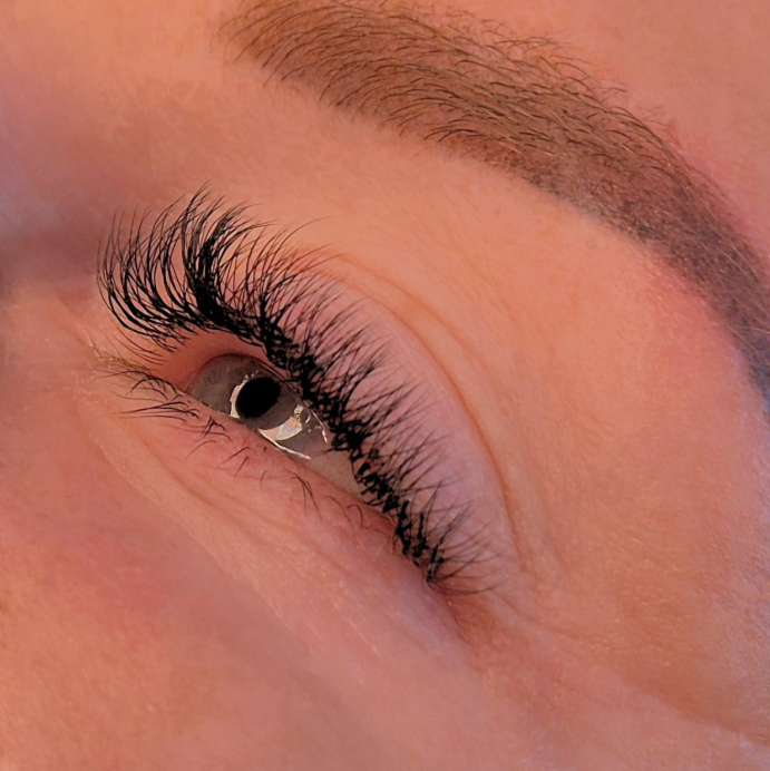 Close-up of a person's eye facing left with hybrid lash extensions by k.beautystudio Aberdeen.