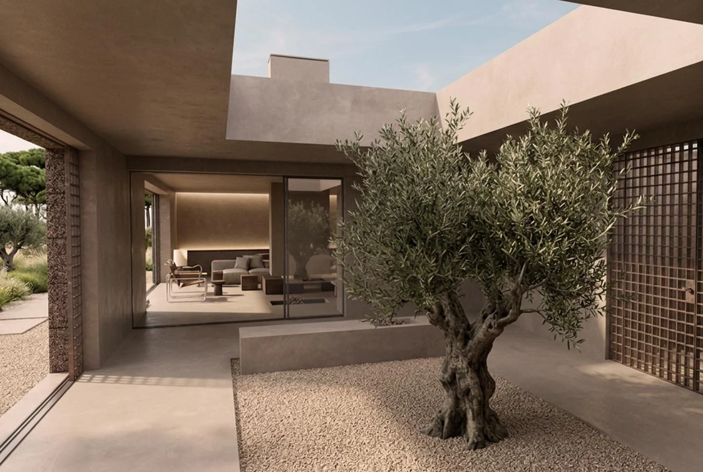 Modern backyard patio with a tree in gravel area, concrete walls, and large glass sliding doors leading into indoor living space with seating.