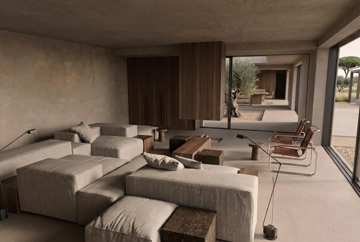 Modern living room with beige sectional sofa, wooden coffee tables, two lounge chairs, and large glass sliding doors opening to outdoor patio with trees.