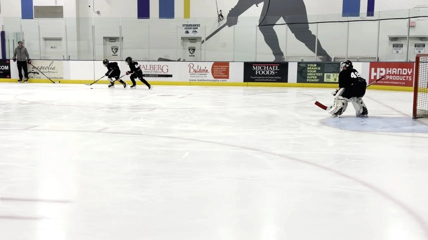 youth hockey players battling for puck