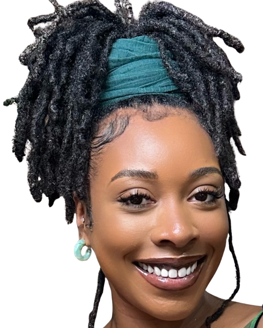 Young woman with dark skin, dreadlocked hair styled up with a teal headwrap, smiling showing white teeth, wearing hoop earrings.