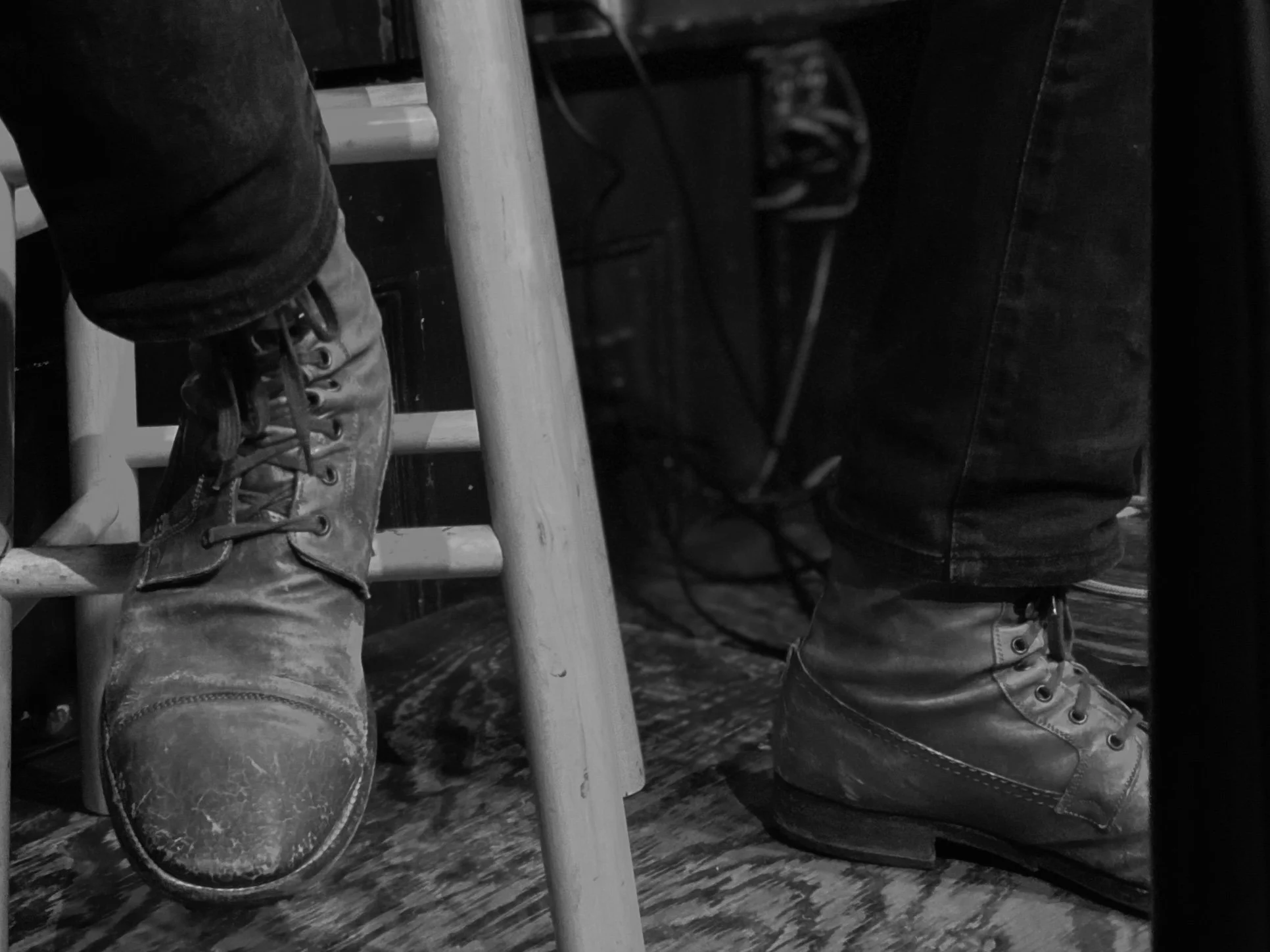 Black-and-white photograph of Joe Stickley in boots and jeans onstage at John D. McGurk’s in St. Louis.