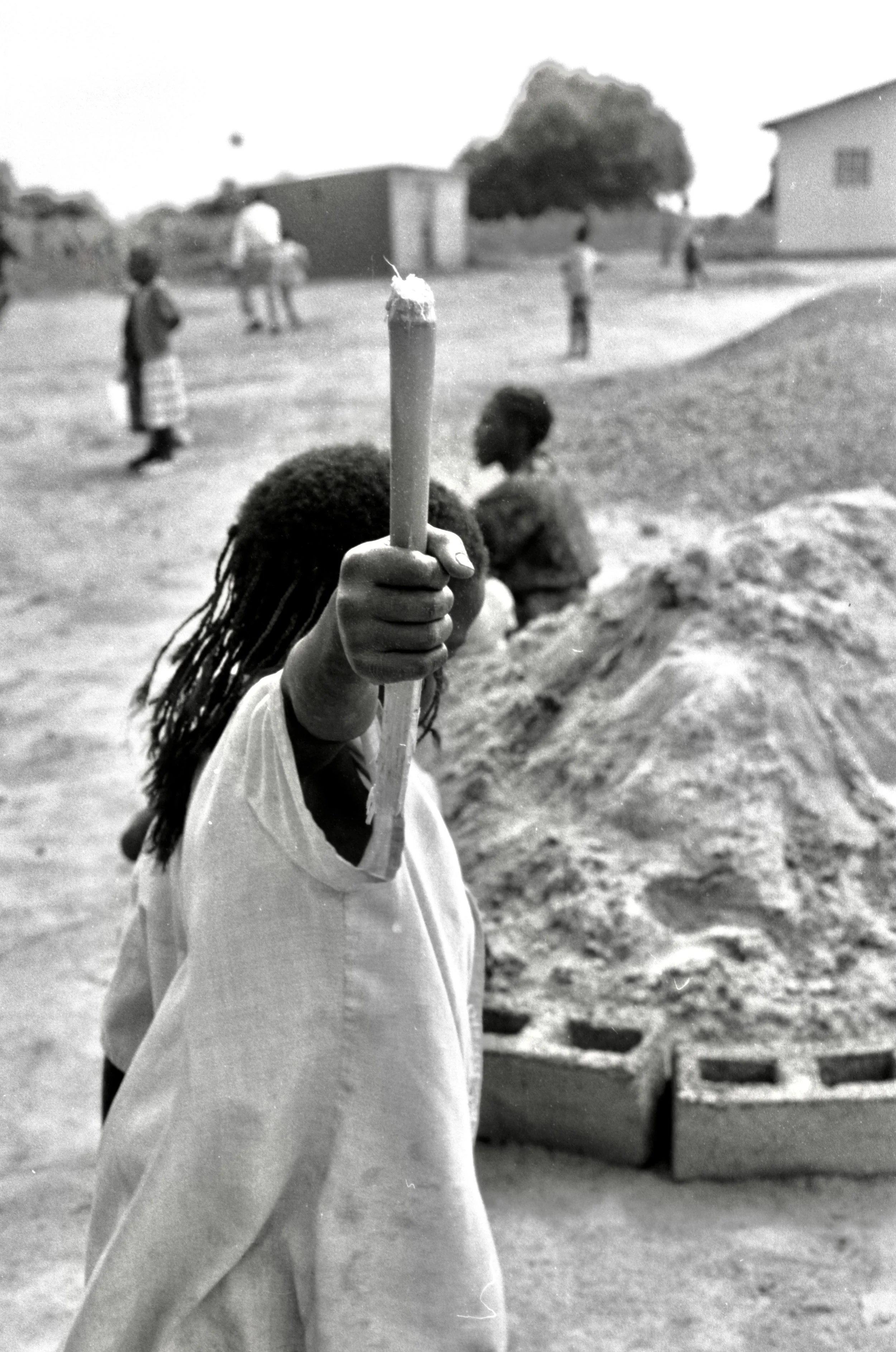 boy holding stick aloft South Africa