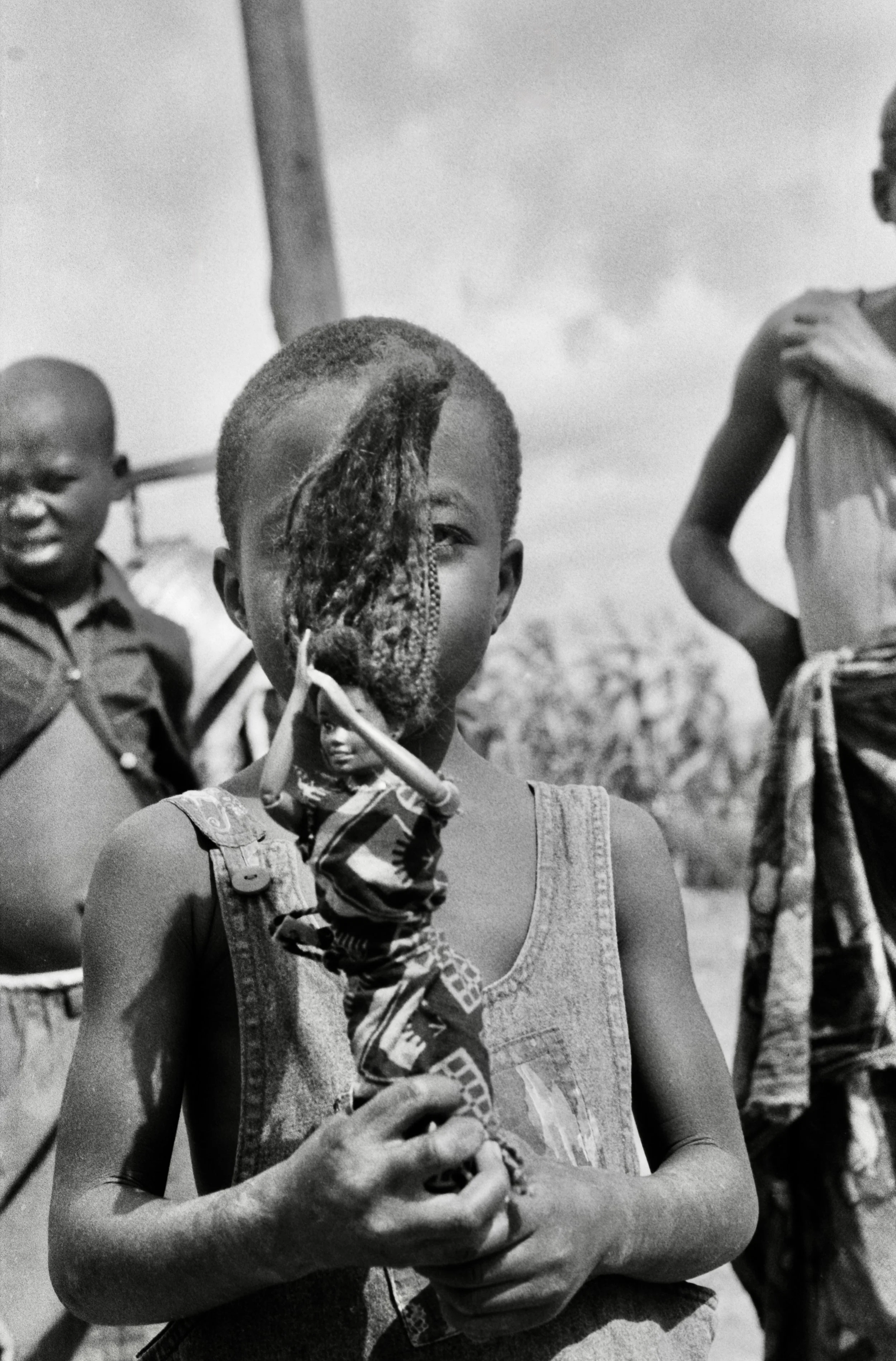 boy holding toy doll Zambia