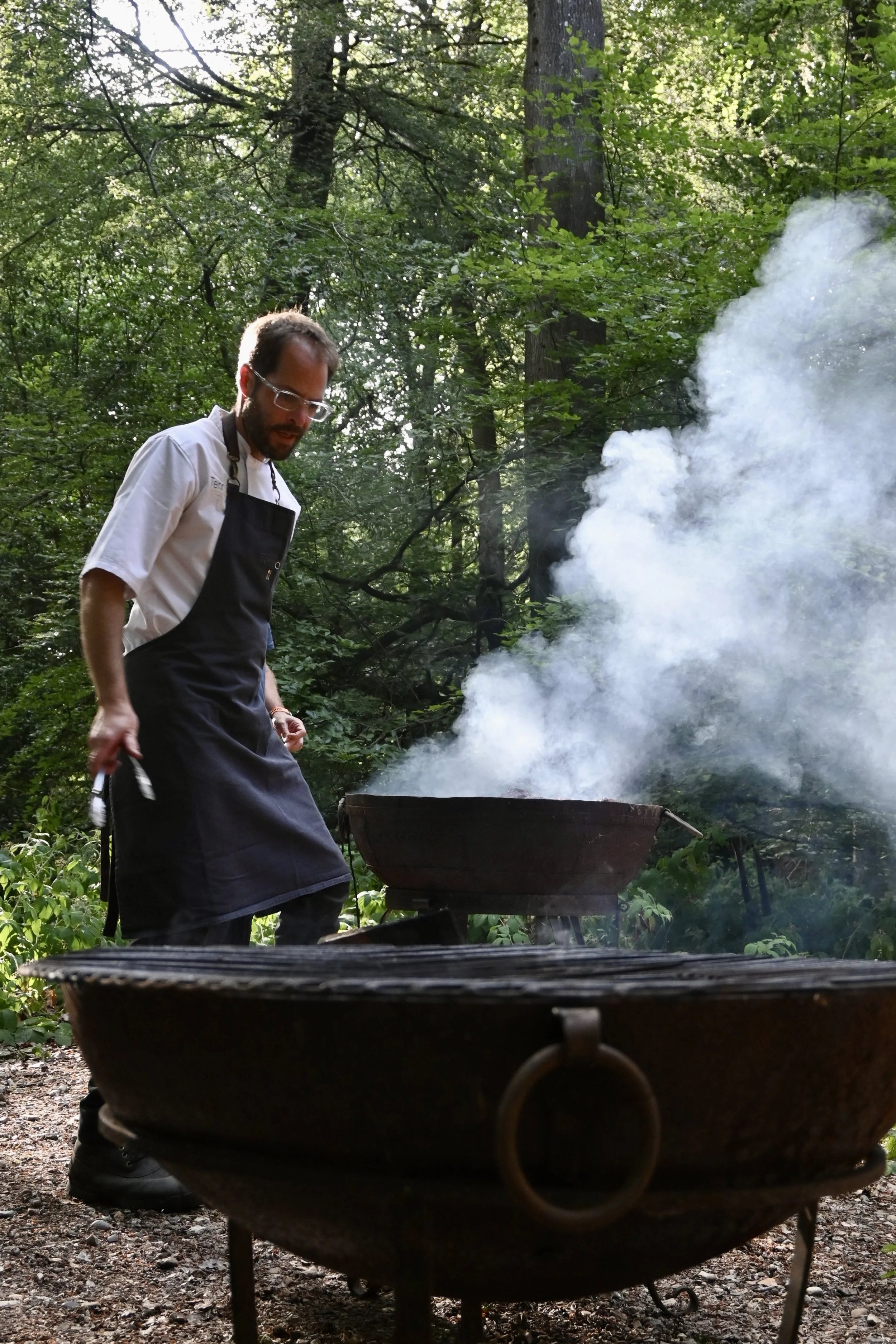 chef cooking over open fire Chilterns woodland