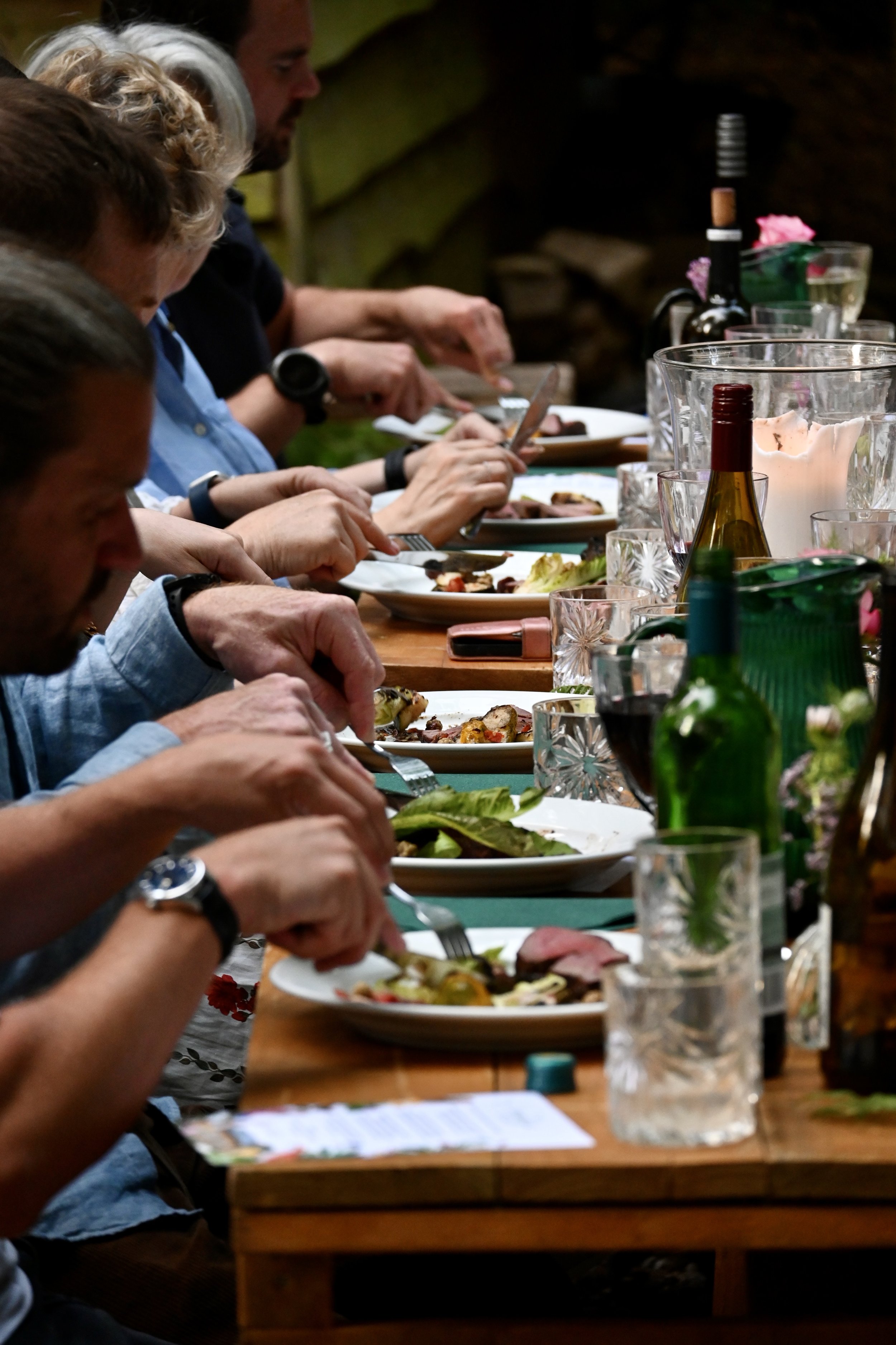diners eating and drinking at outdoor woodland feast Chilterns