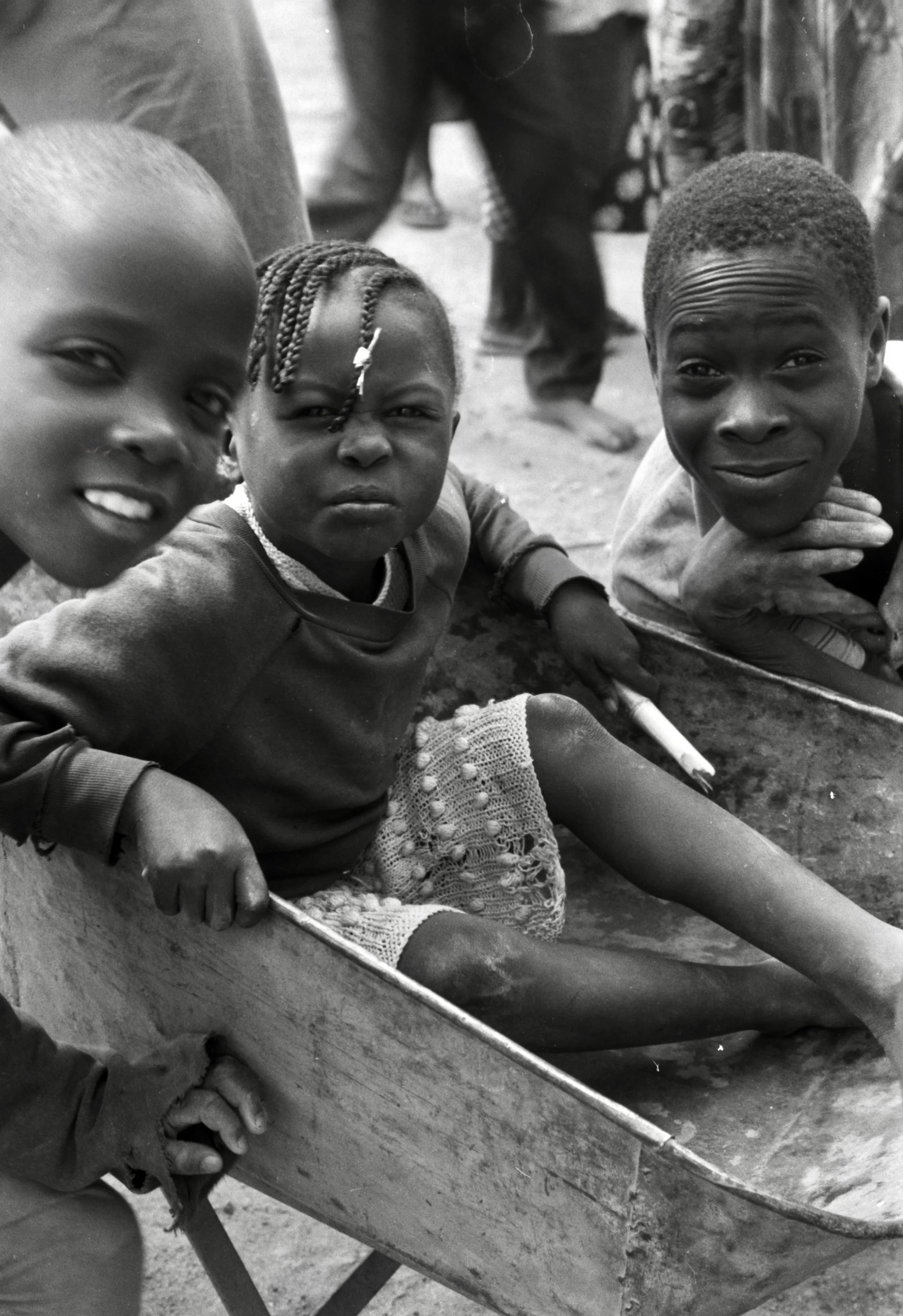 children playing in wheel barrow Zambia