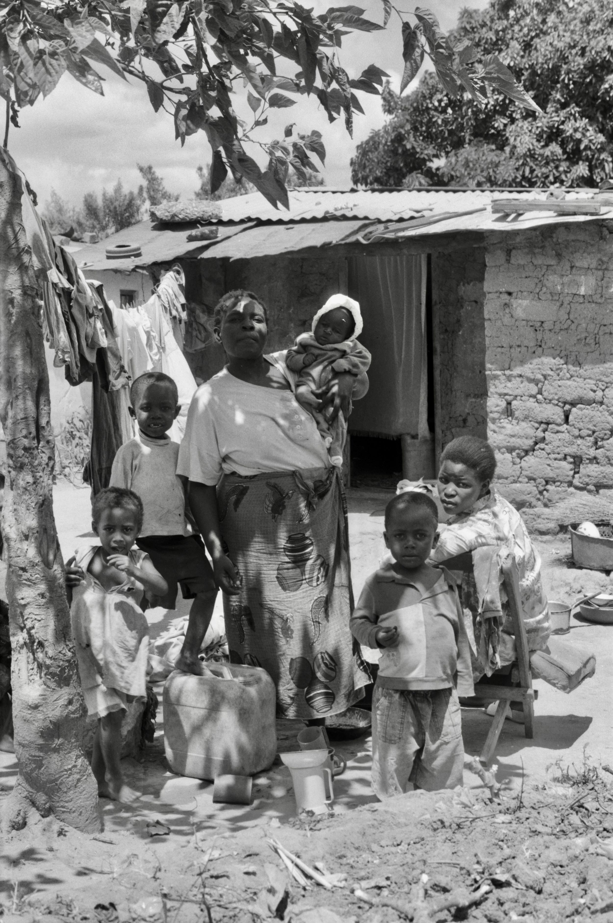 family gathered outside house Zambia