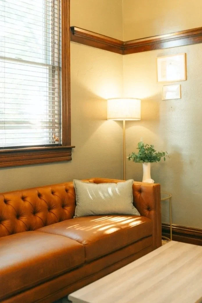 leather couch, lamp, and coffee table