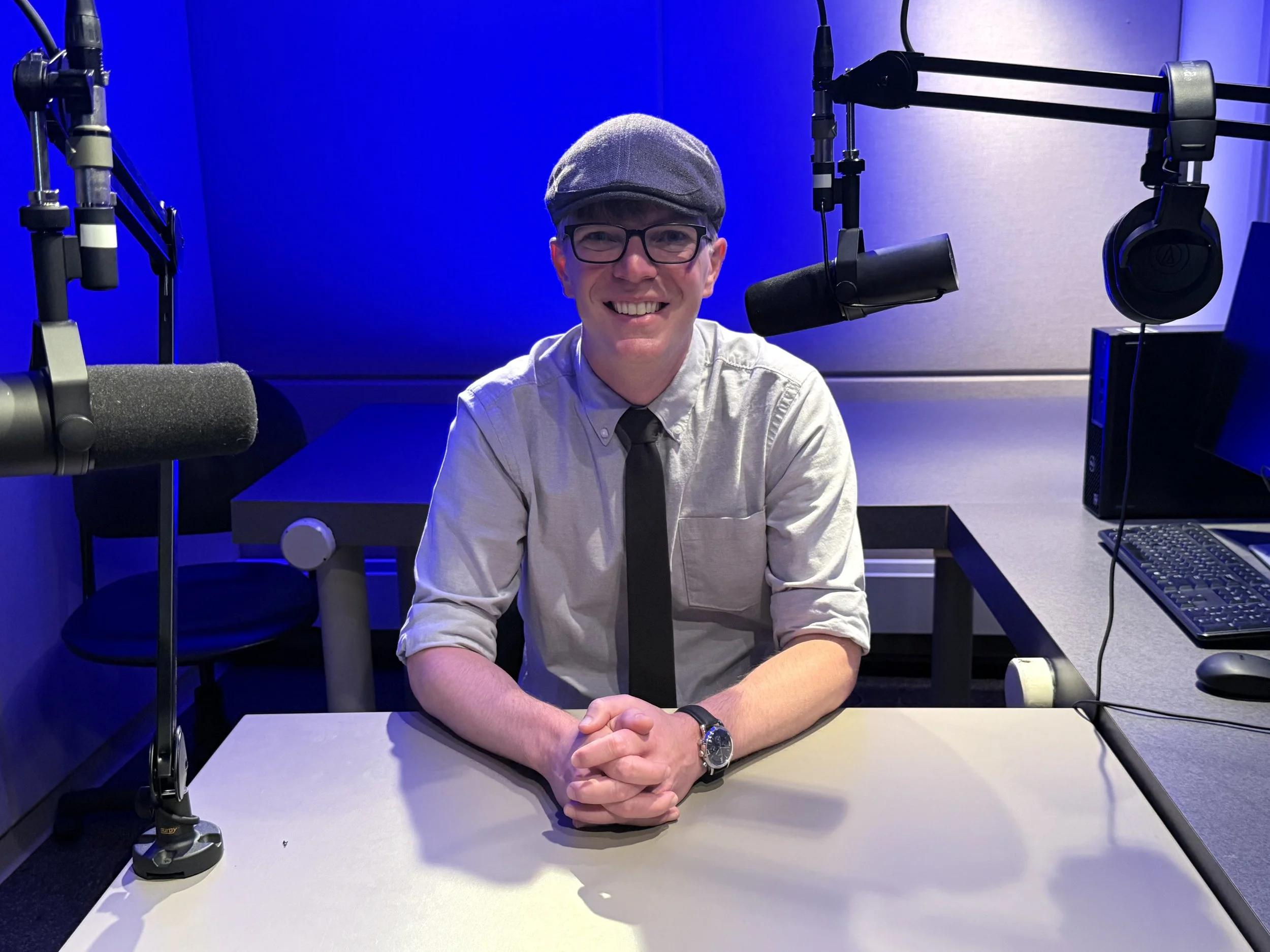 Dr. C. Kyle Rudick, sitting in a podcast studio, ready to record an episode of the Publishing Academic Resarch podcast
