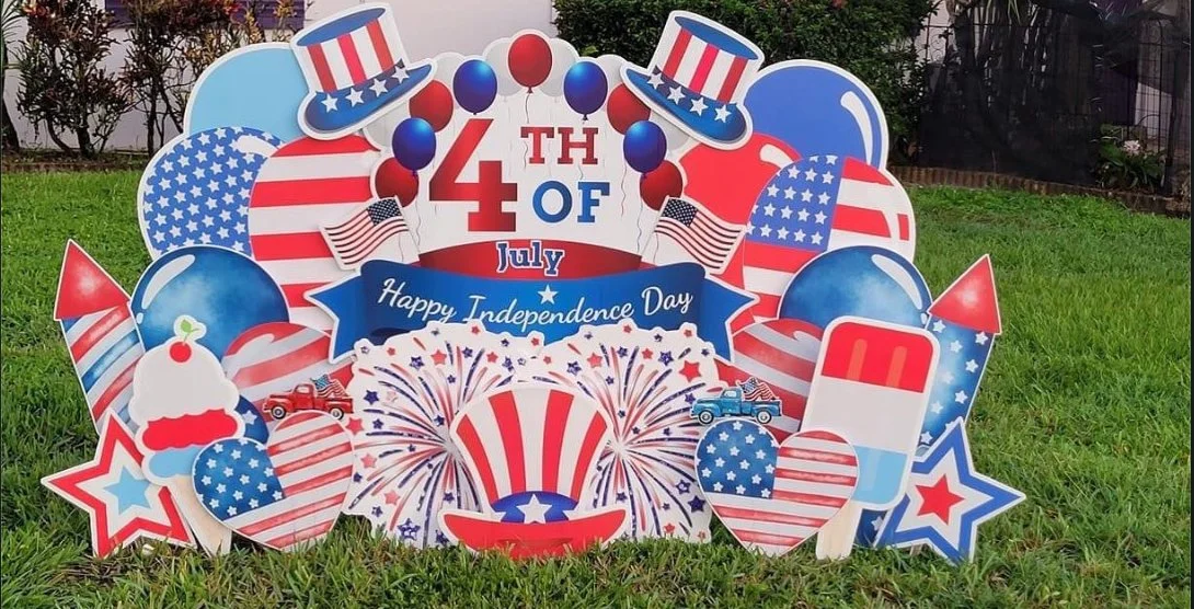 Patriotic Fourth of July Independence Day decoration with balloons, hats, flags, fireworks, and red, white, and blue themed items.