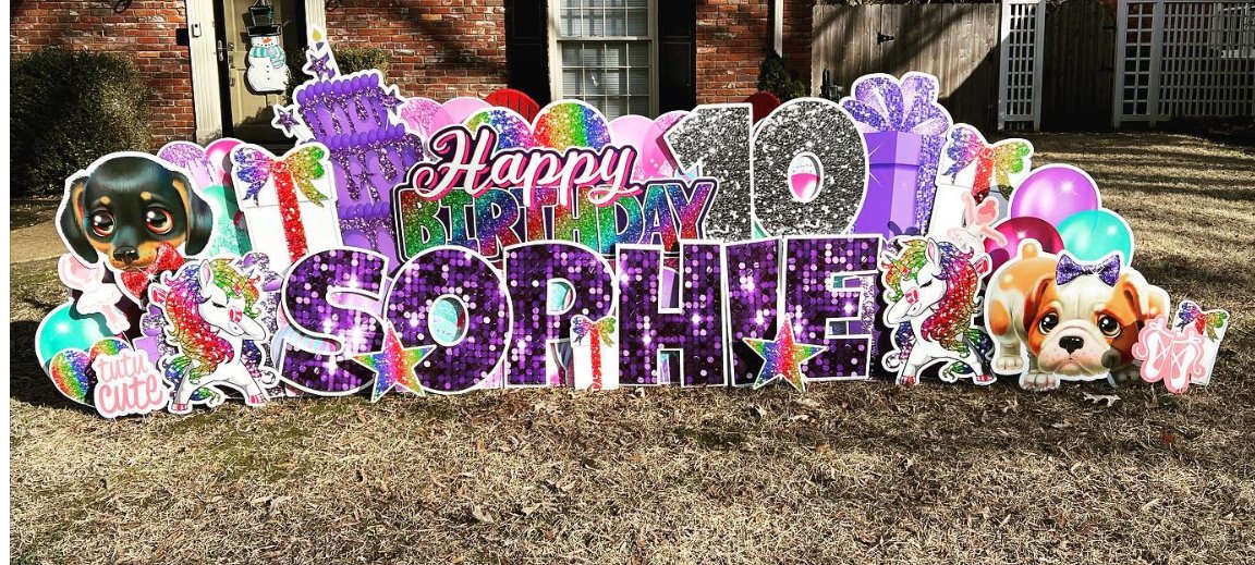 Colorful birthday yard sign featuring the message "Happy 10th Sophie," with unicorn, dog, and balloon decorations in a residential yard.