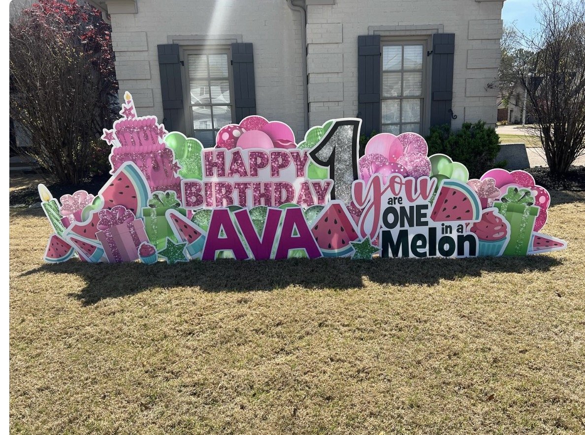 Colorful birthday yard decoration celebrating a first birthday with watermelon, cupcake, and gift illustrations, and the text "Happy Birthday Ava" and "You are one in a Melon."