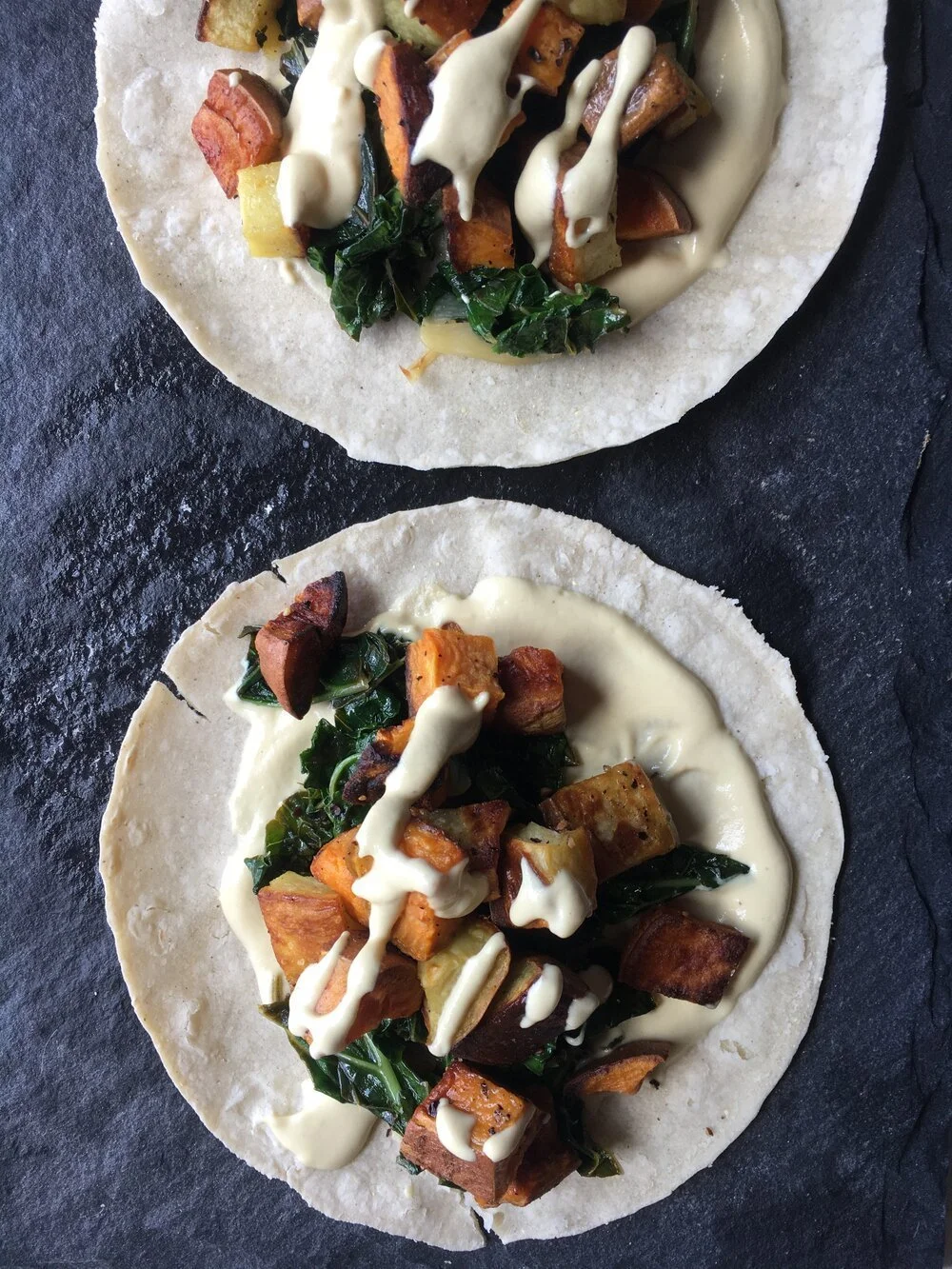 Vegan sweet potato and kale tacos with cashew cream.