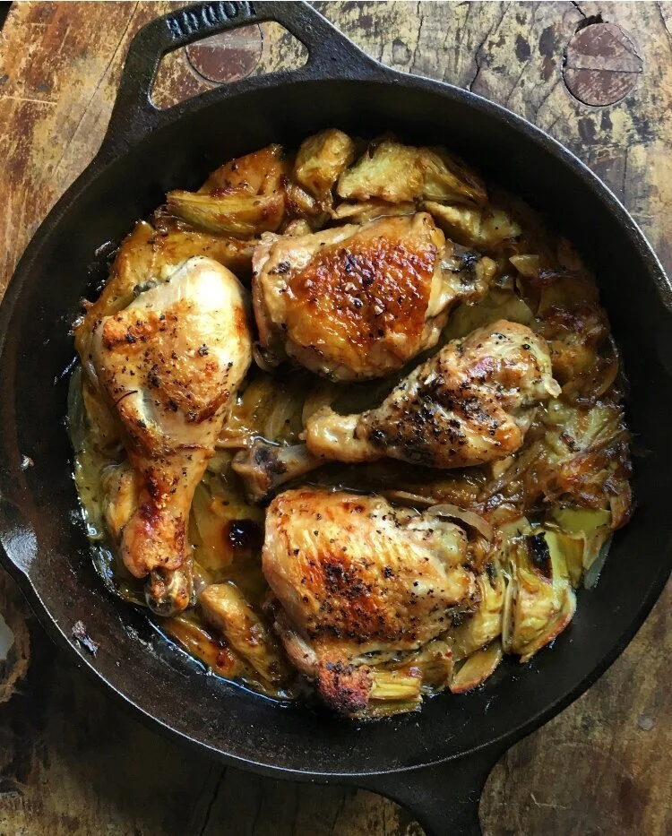 Braised chicken with artichokes, garlic, shallots, and lemon.