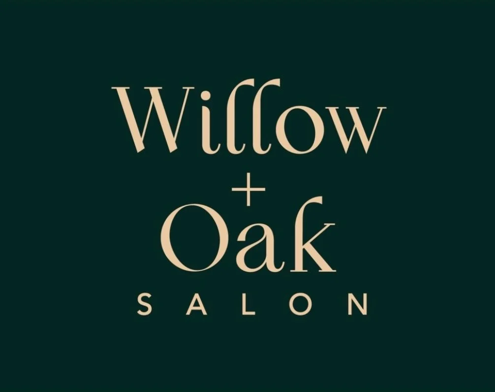 Logo of Wiltow + Oak Salon with beige text on a dark background.