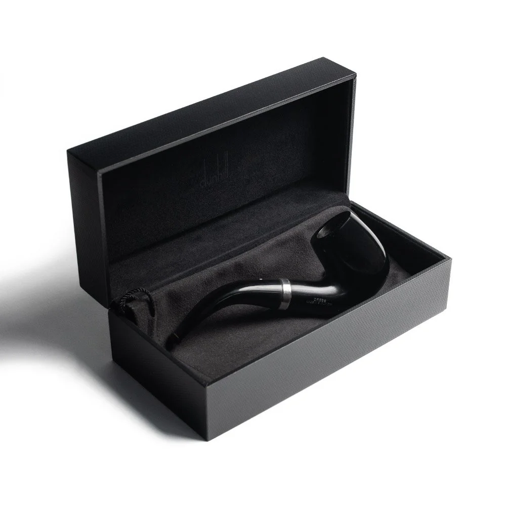A black shoehorn inside a black presentation box with a foam insert.