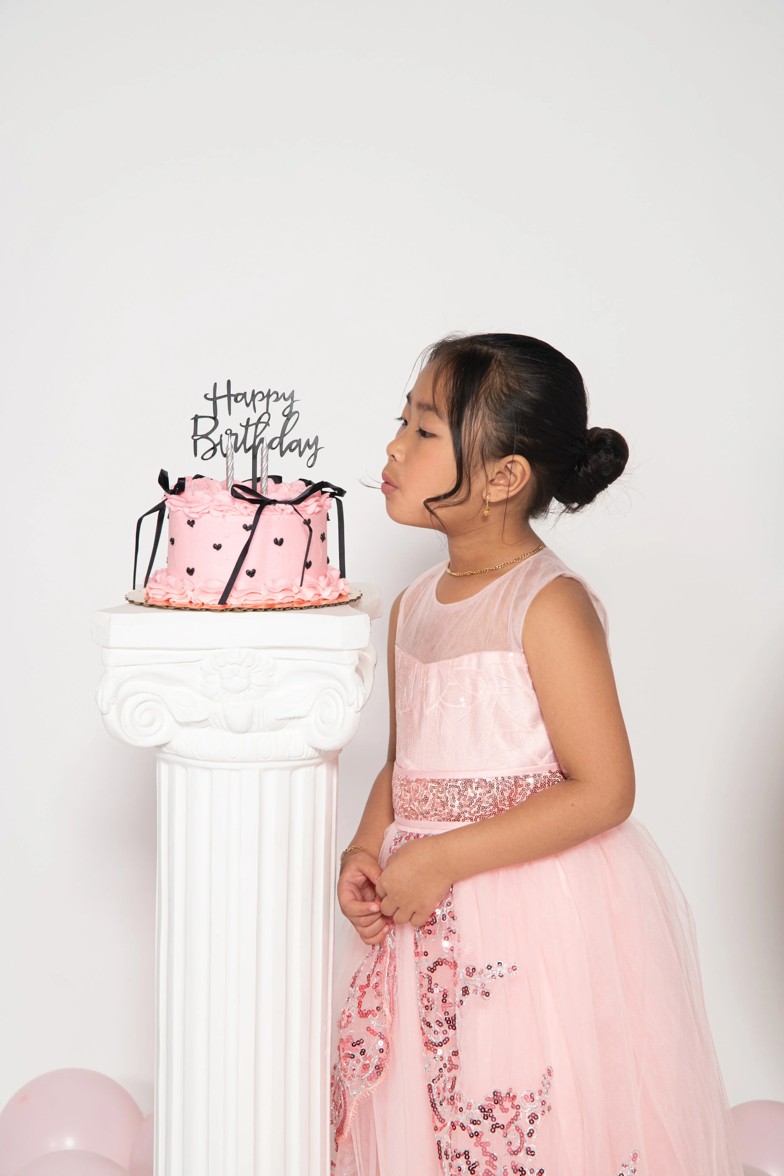 Little girl blowing out birthday candles