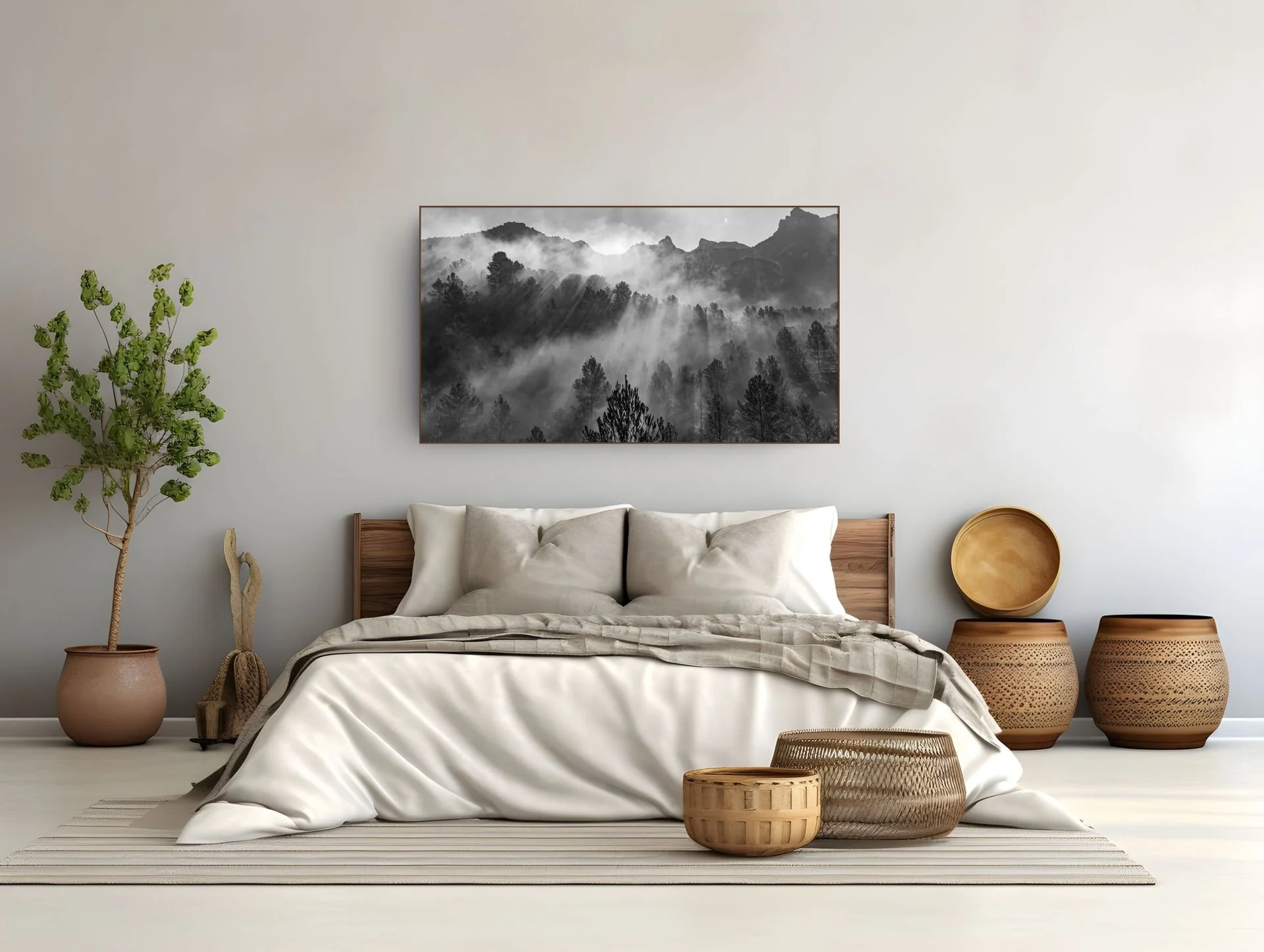 Misty black and white forest landscape hung above a bed, bedroom wall art