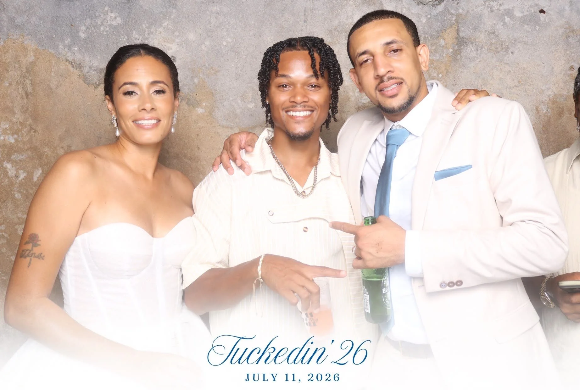 Three guests standing together in formal attire at an event, smiling and posing for a photo at a celebration in Bermuda
