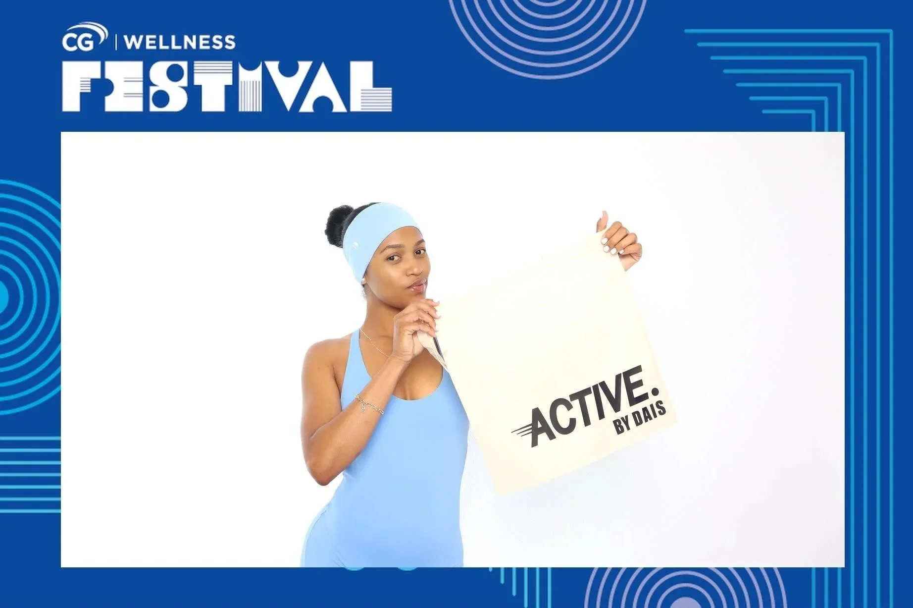 Guest posing in a custom branded frame at a CG corporate wellness event