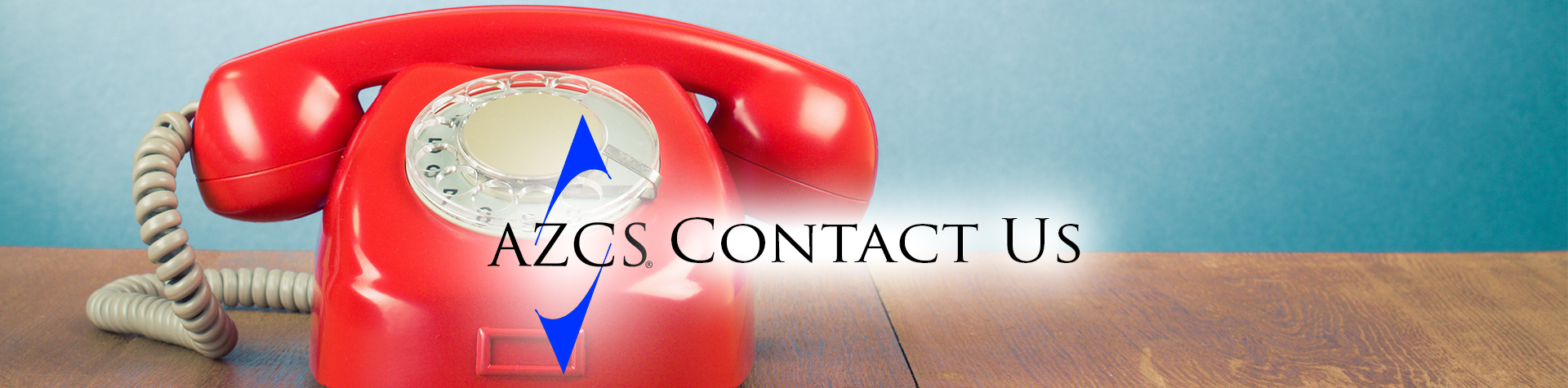Red vintage rotary telephone on a wooden surface with text 'AZCS Contact Us' overlaid.